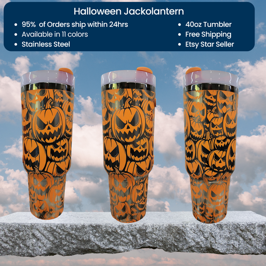 three halloween themed tumblers sitting on top of a rock