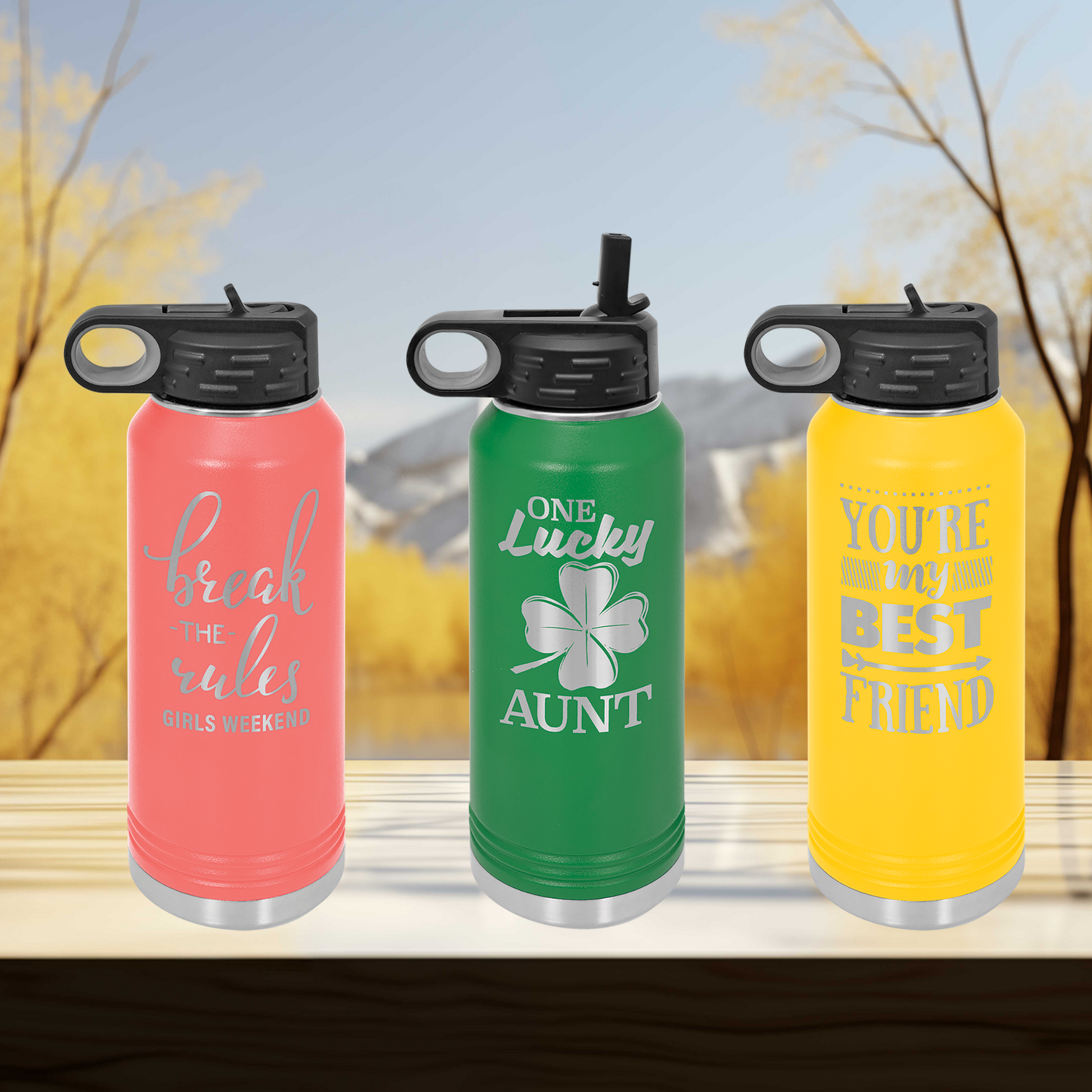 a group of three water bottles sitting on top of a wooden table