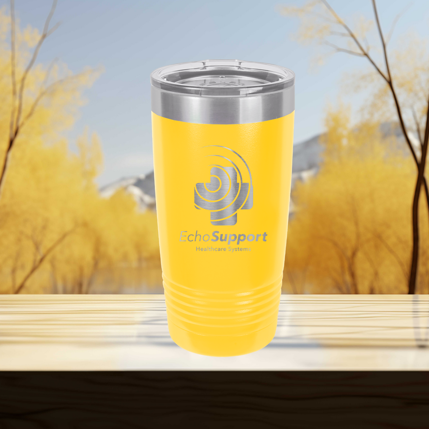a yellow tumbler cup sitting on top of a wooden table
