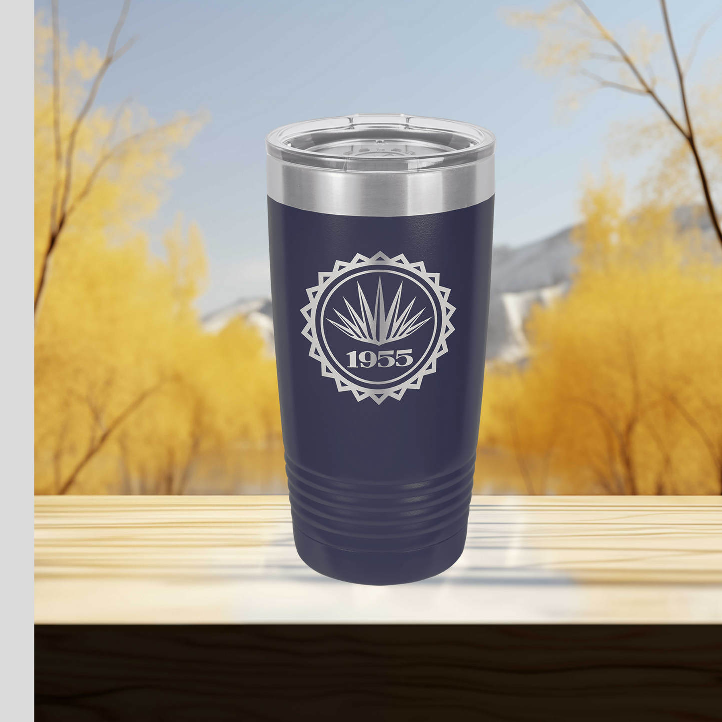 a blue tumbler cup sitting on top of a wooden table