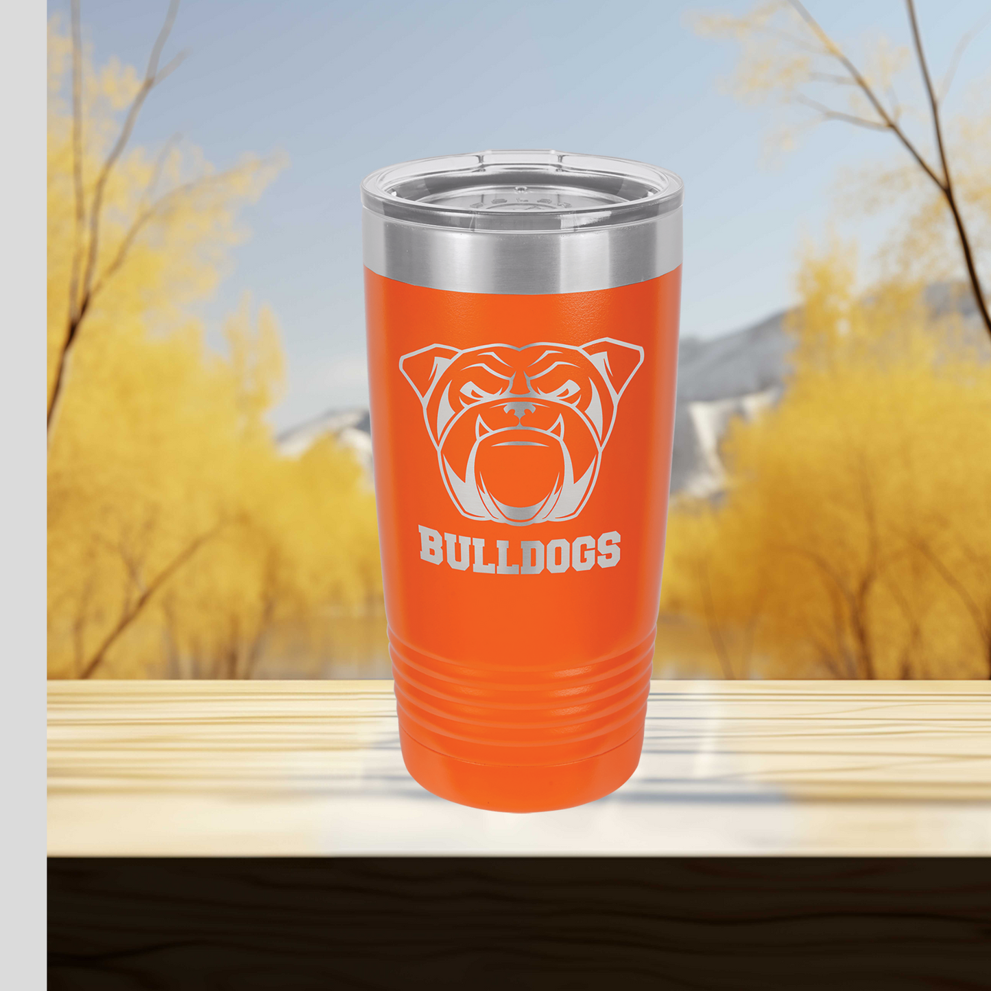 an orange tumbler cup with a bulldog logo on it