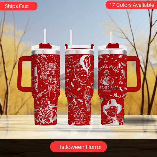 three red travel mugs with white designs on them