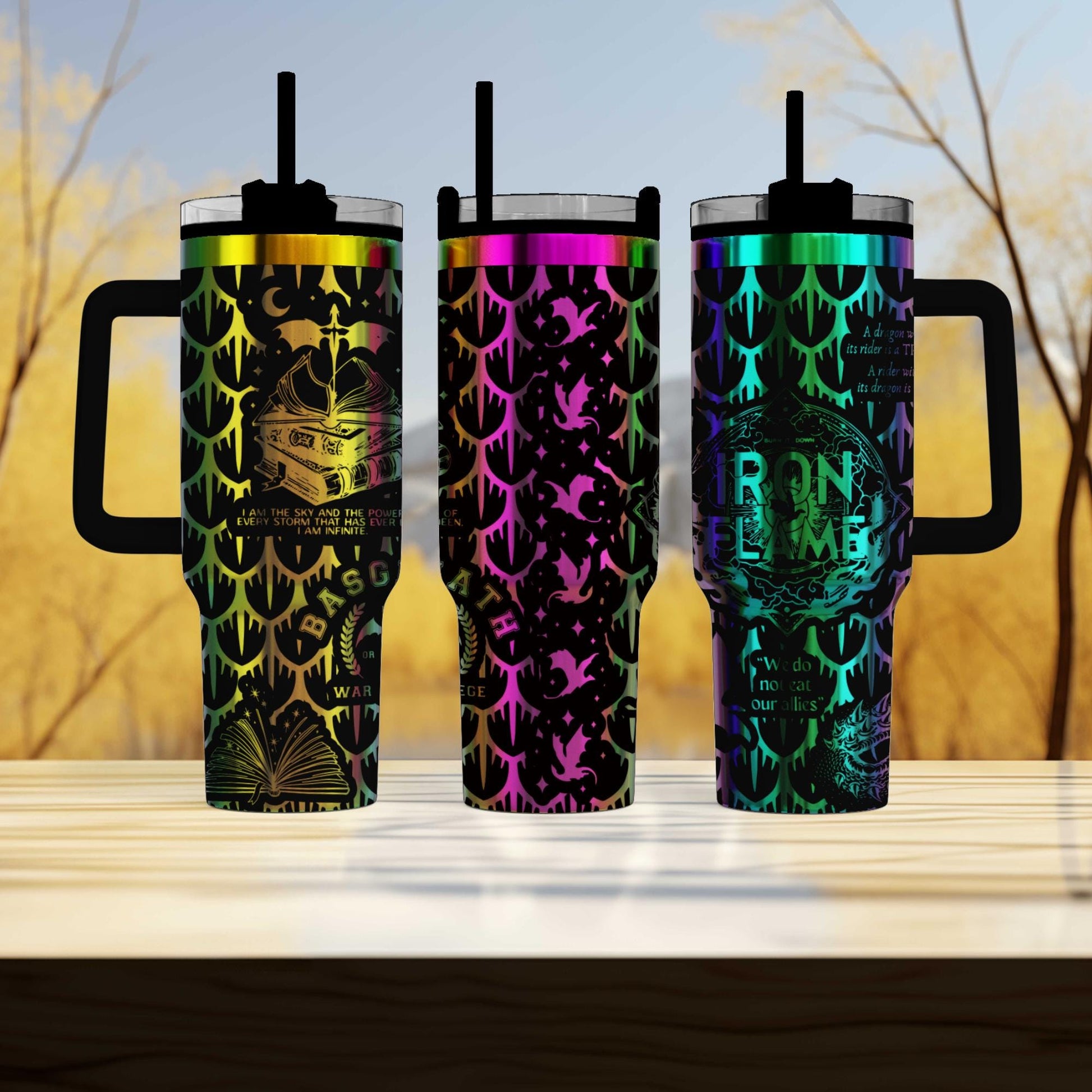 three travel mugs sitting on top of a wooden table