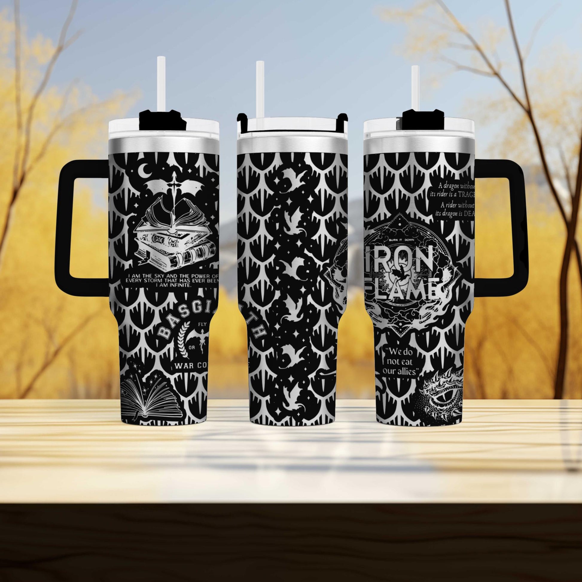 three travel mugs sitting on top of a wooden table