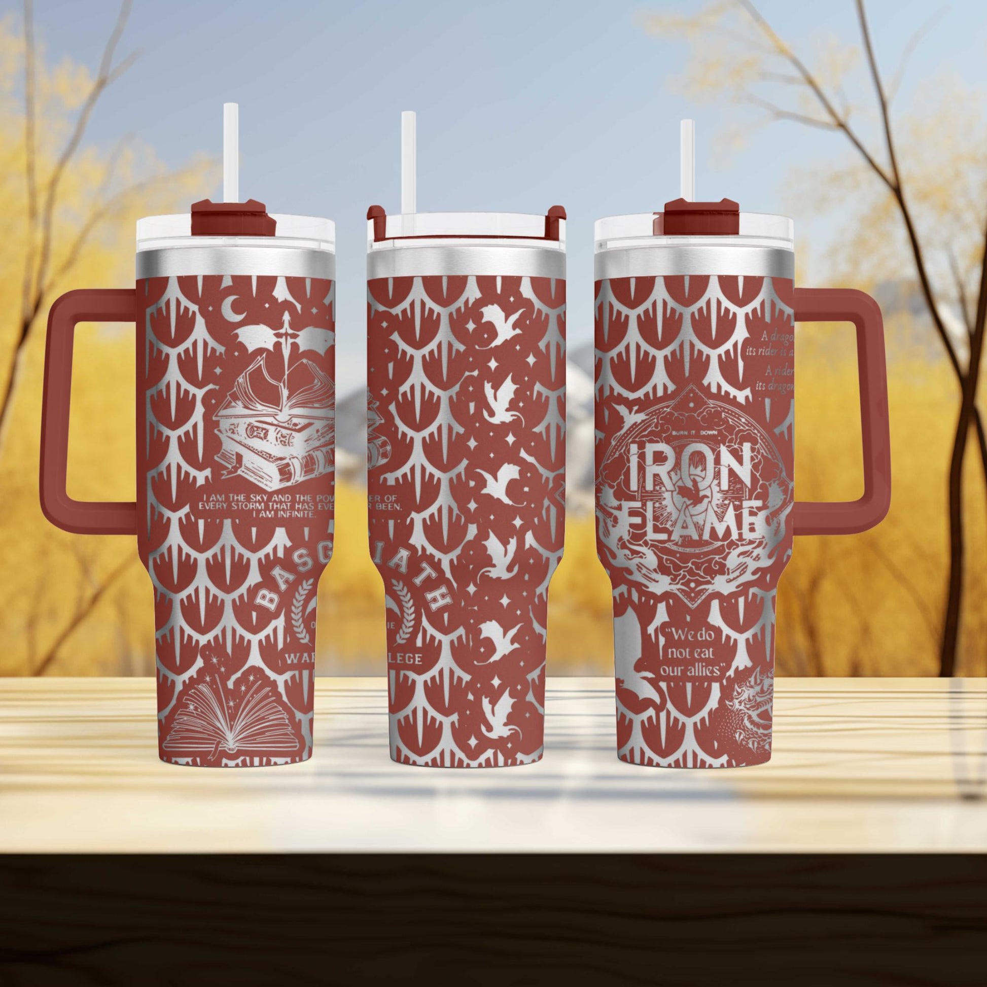 two red travel mugs sitting on top of a wooden table