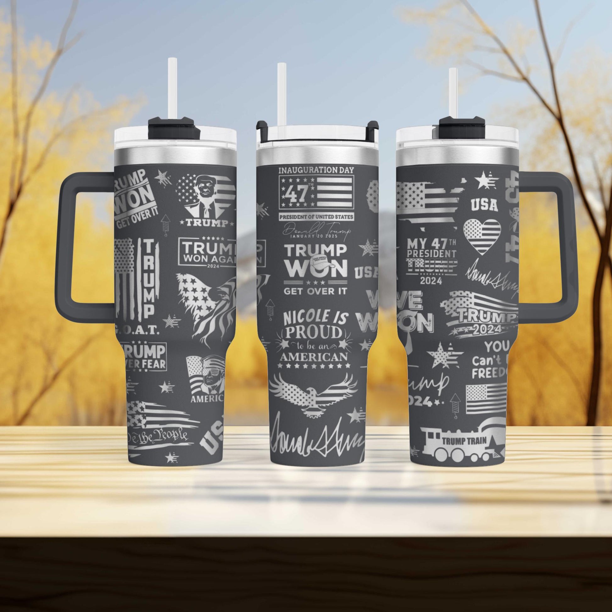 three travel mugs sitting on top of a wooden table