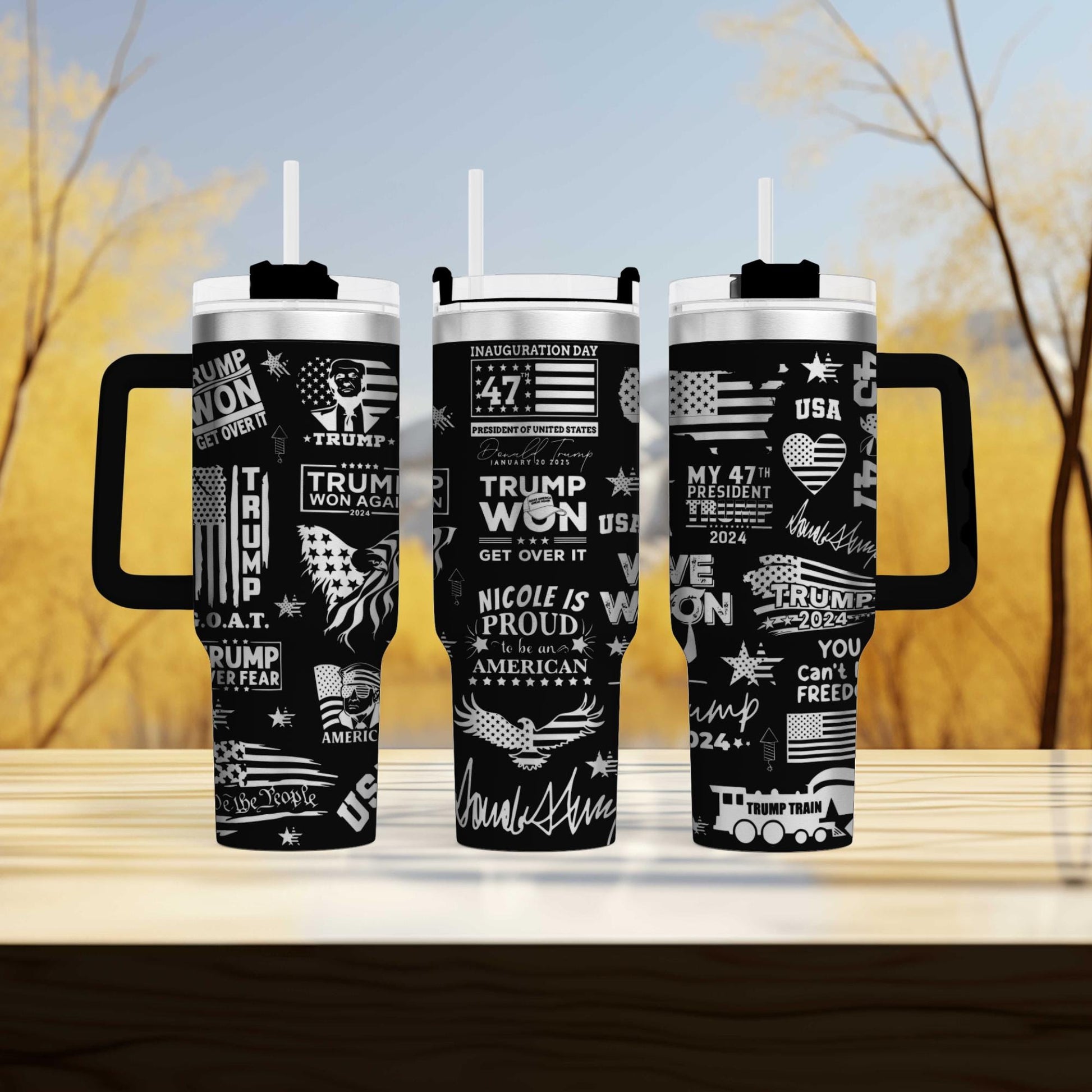 three travel mugs sitting on top of a wooden table