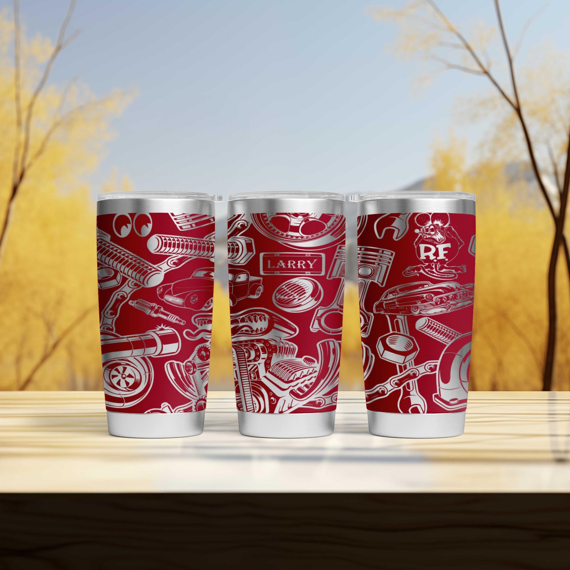 three red tumblers sitting on top of a wooden table
