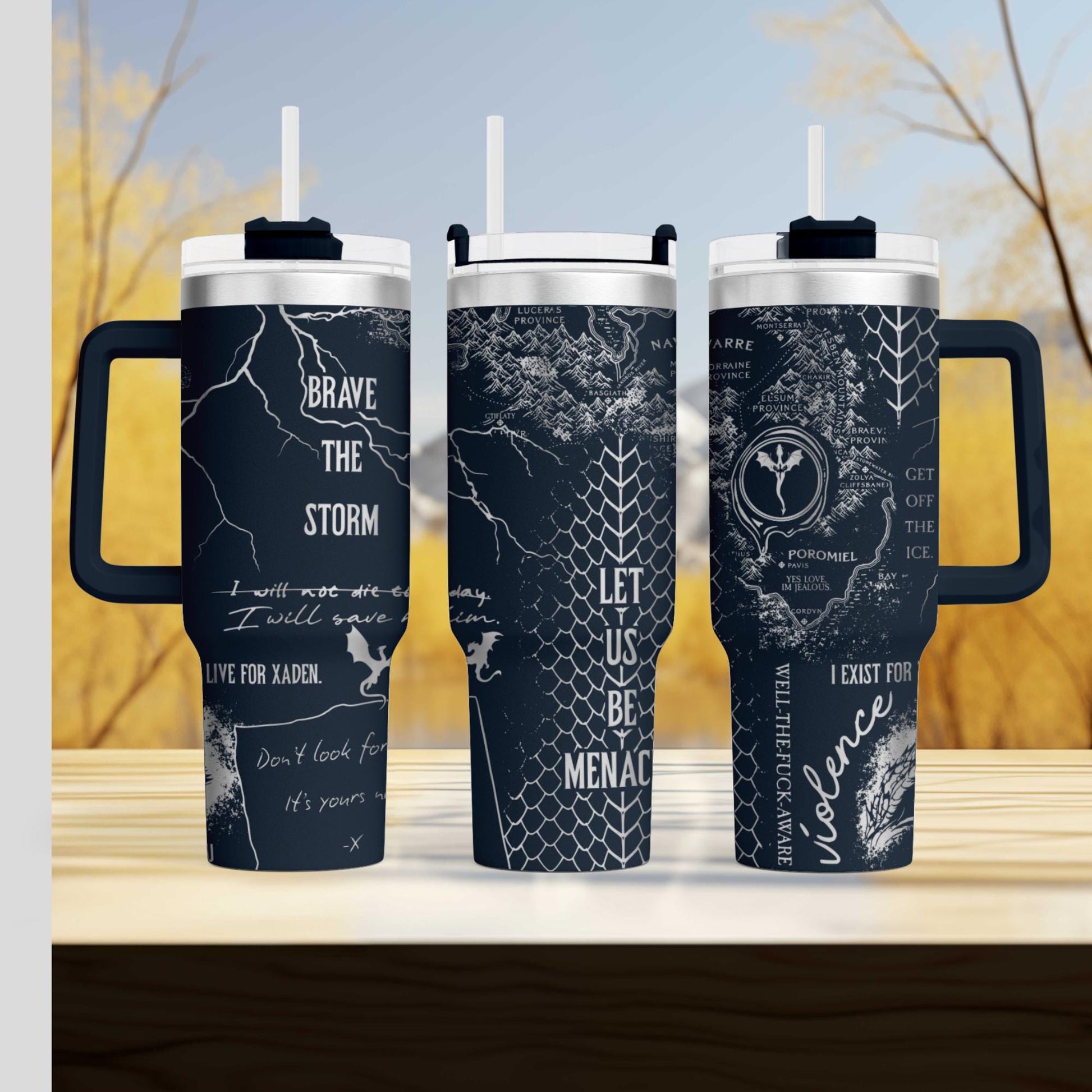 three travel mugs sitting on top of a wooden table