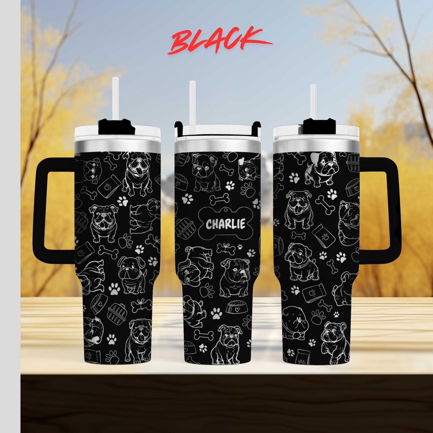 a couple of black cups sitting on top of a wooden table