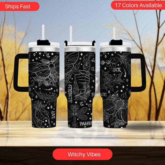 two travel mugs sitting on top of a table