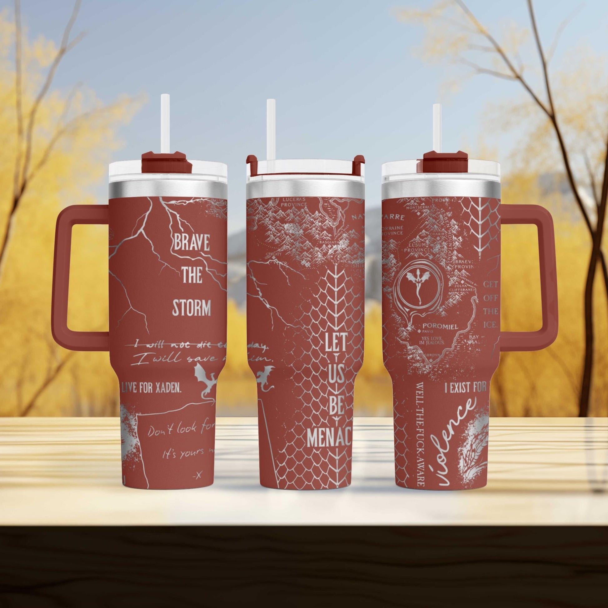 three travel mugs sitting on top of a wooden table