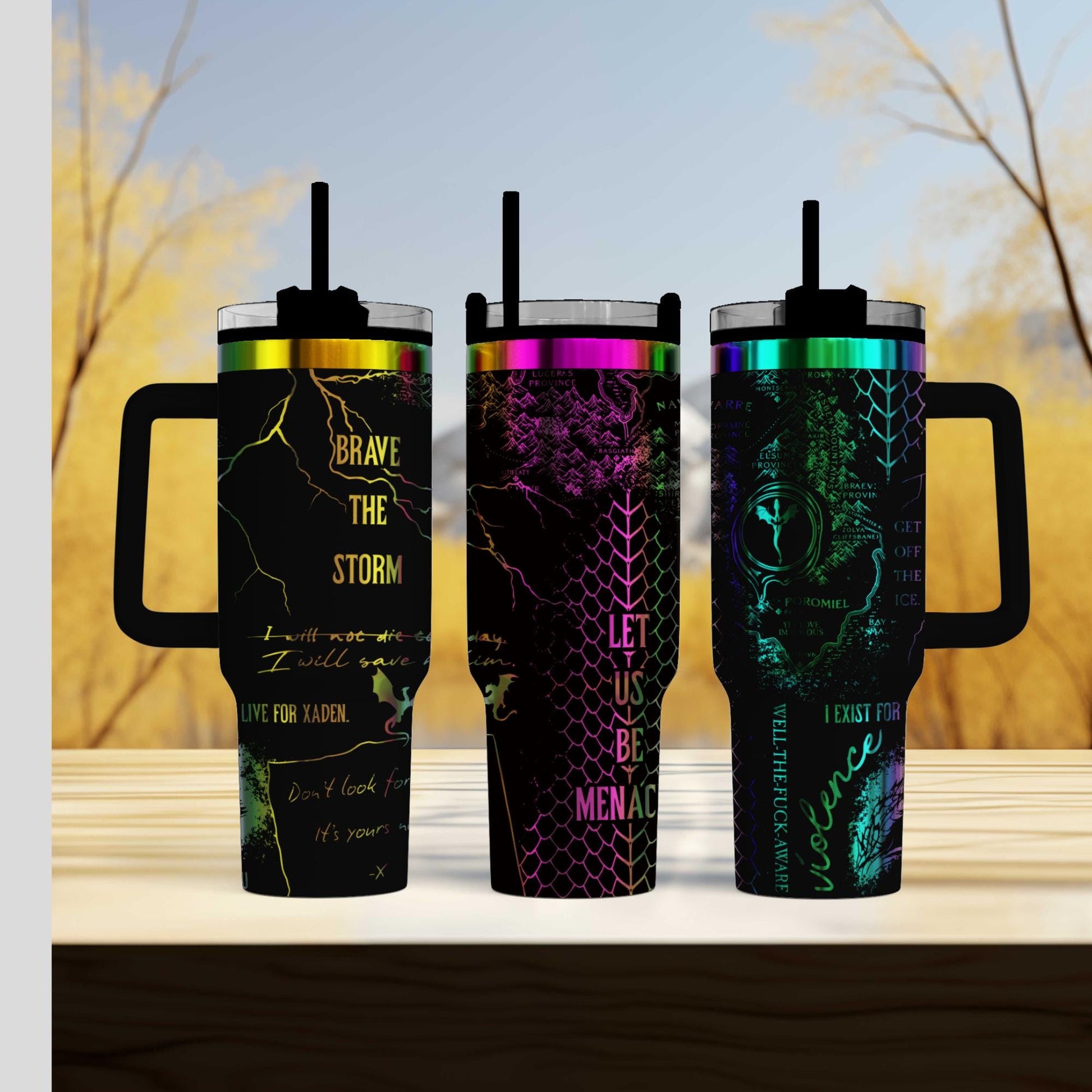 three travel mugs sitting on top of a wooden table