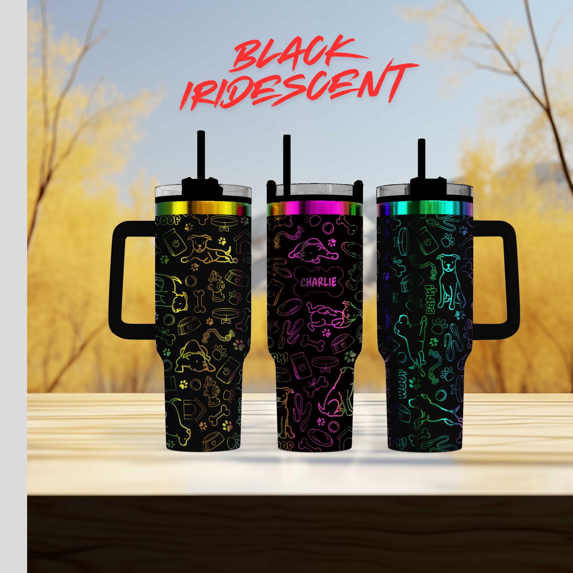 three different colored tumblers sitting on top of a wooden table