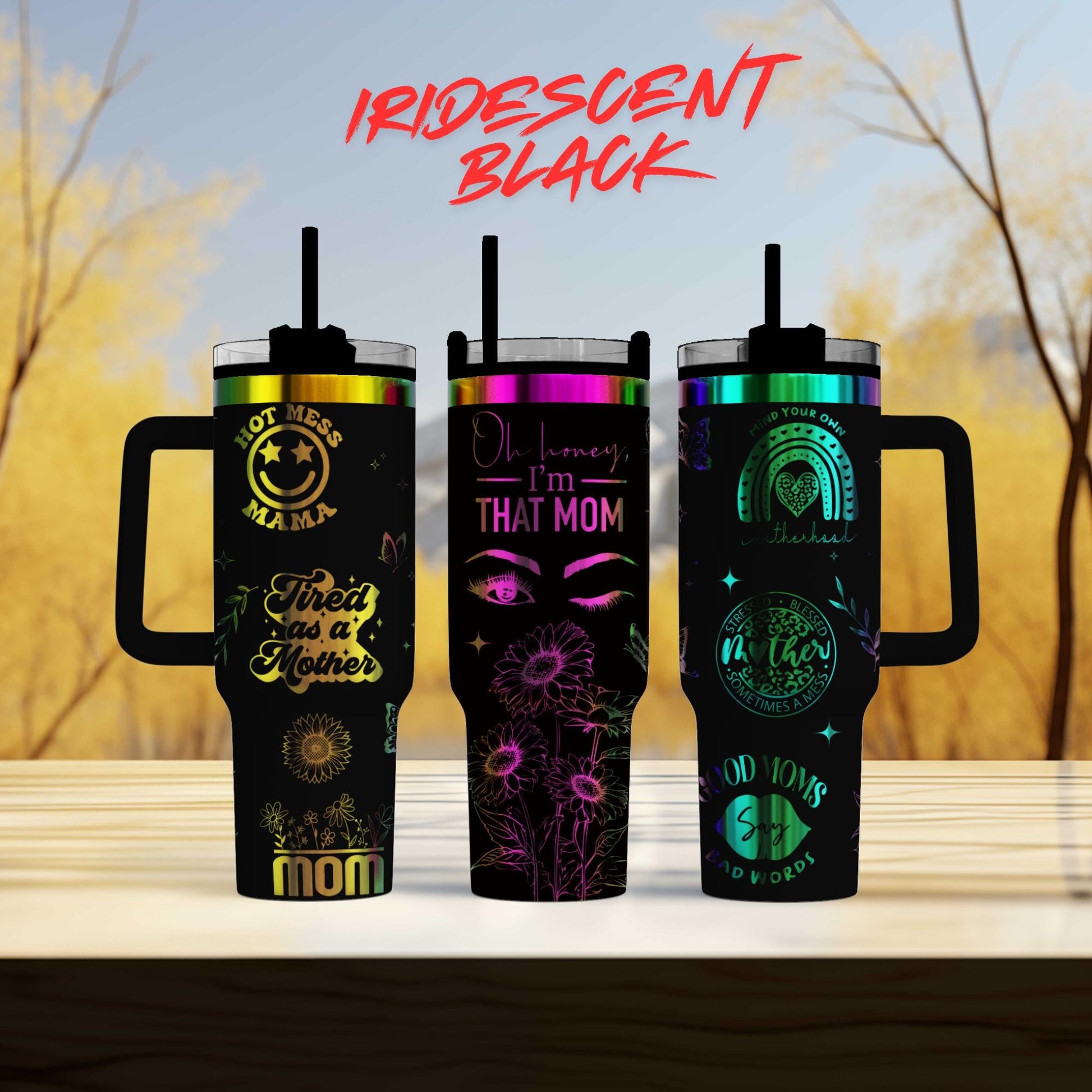 three different colored tumblers sitting on top of a table