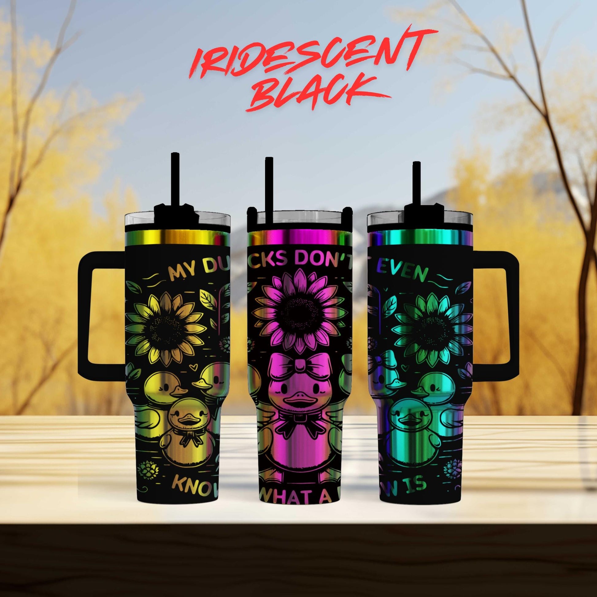 three colorful tumblers sitting on top of a wooden table