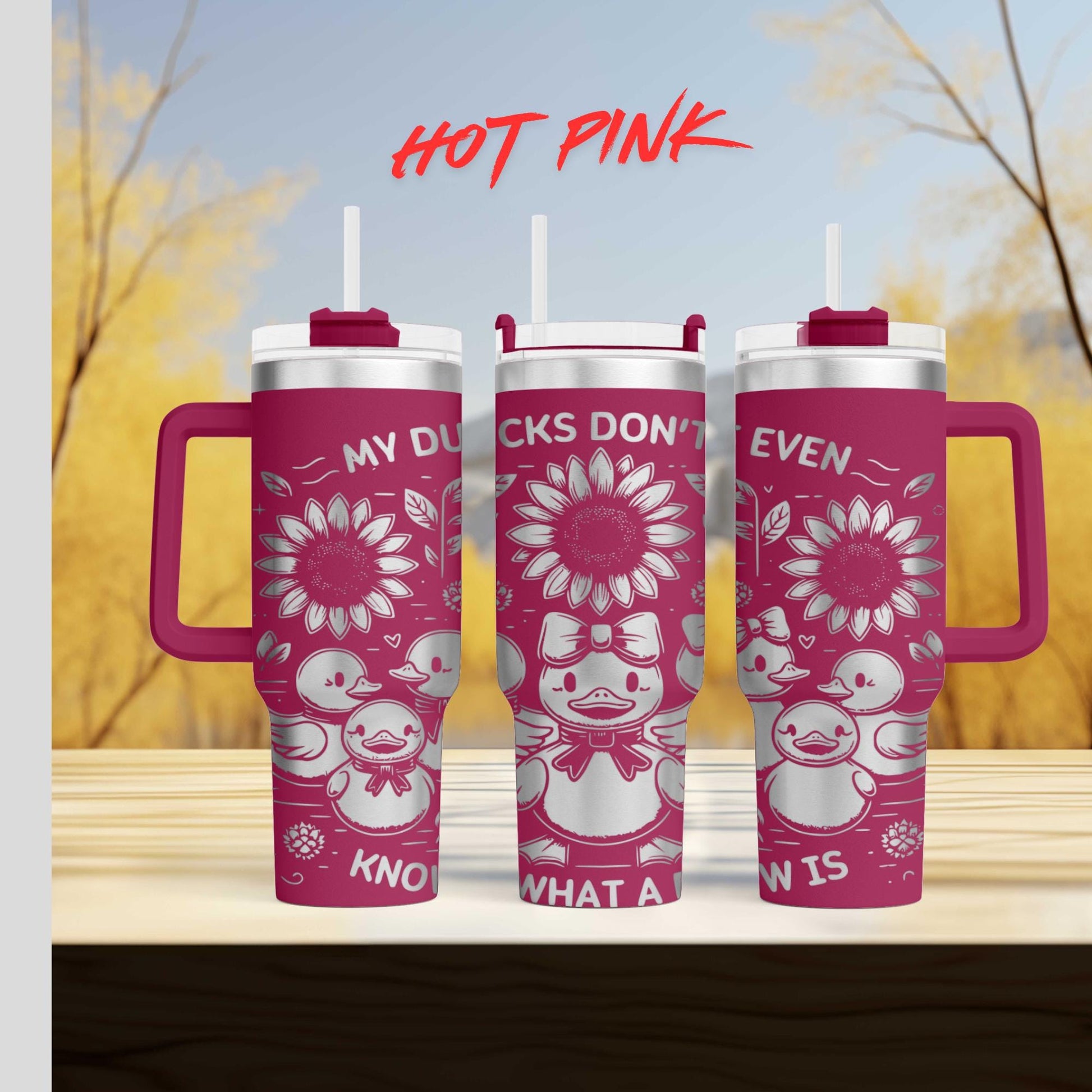 three pink tumblers sitting on top of a wooden table