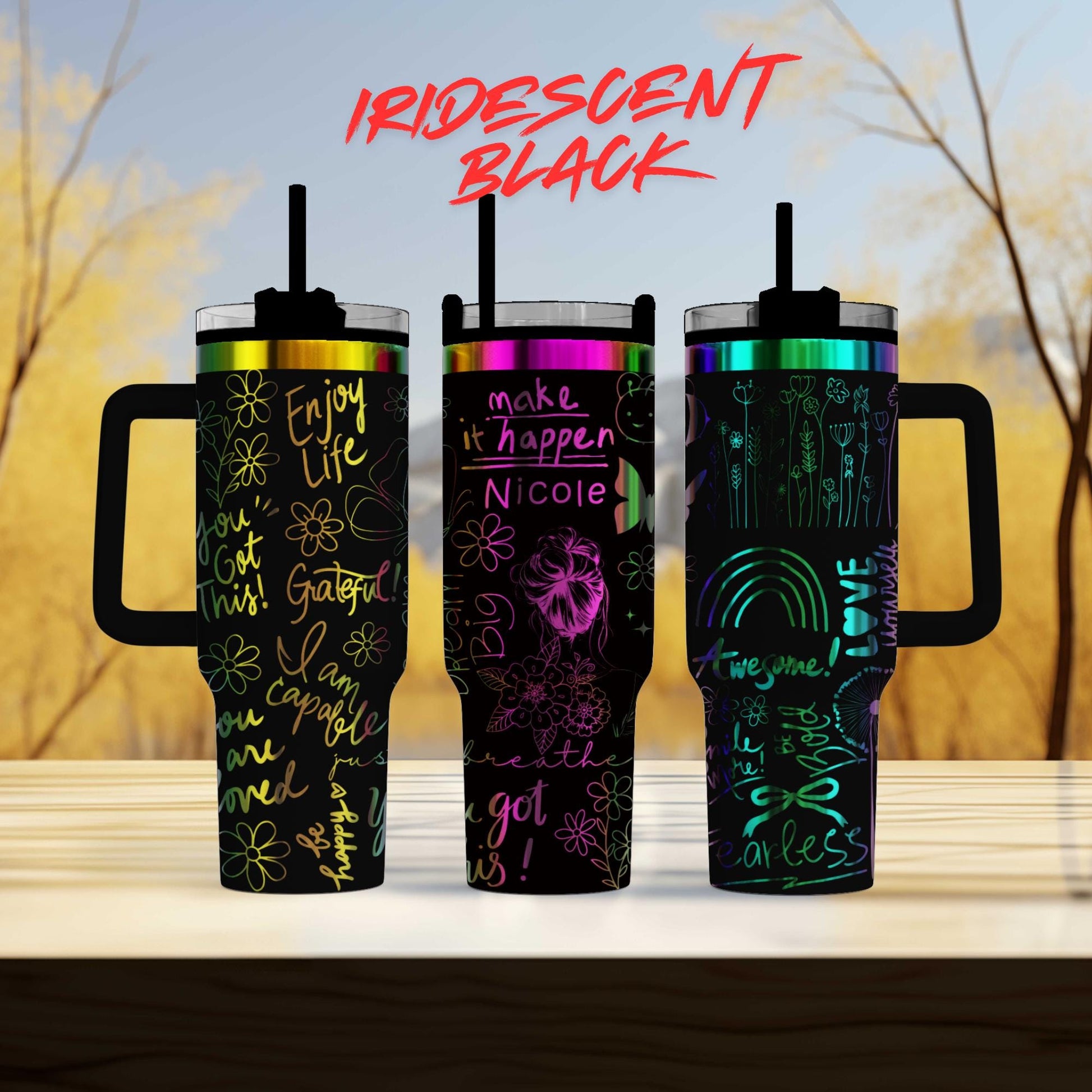 three different colored tumblers sitting on top of a table