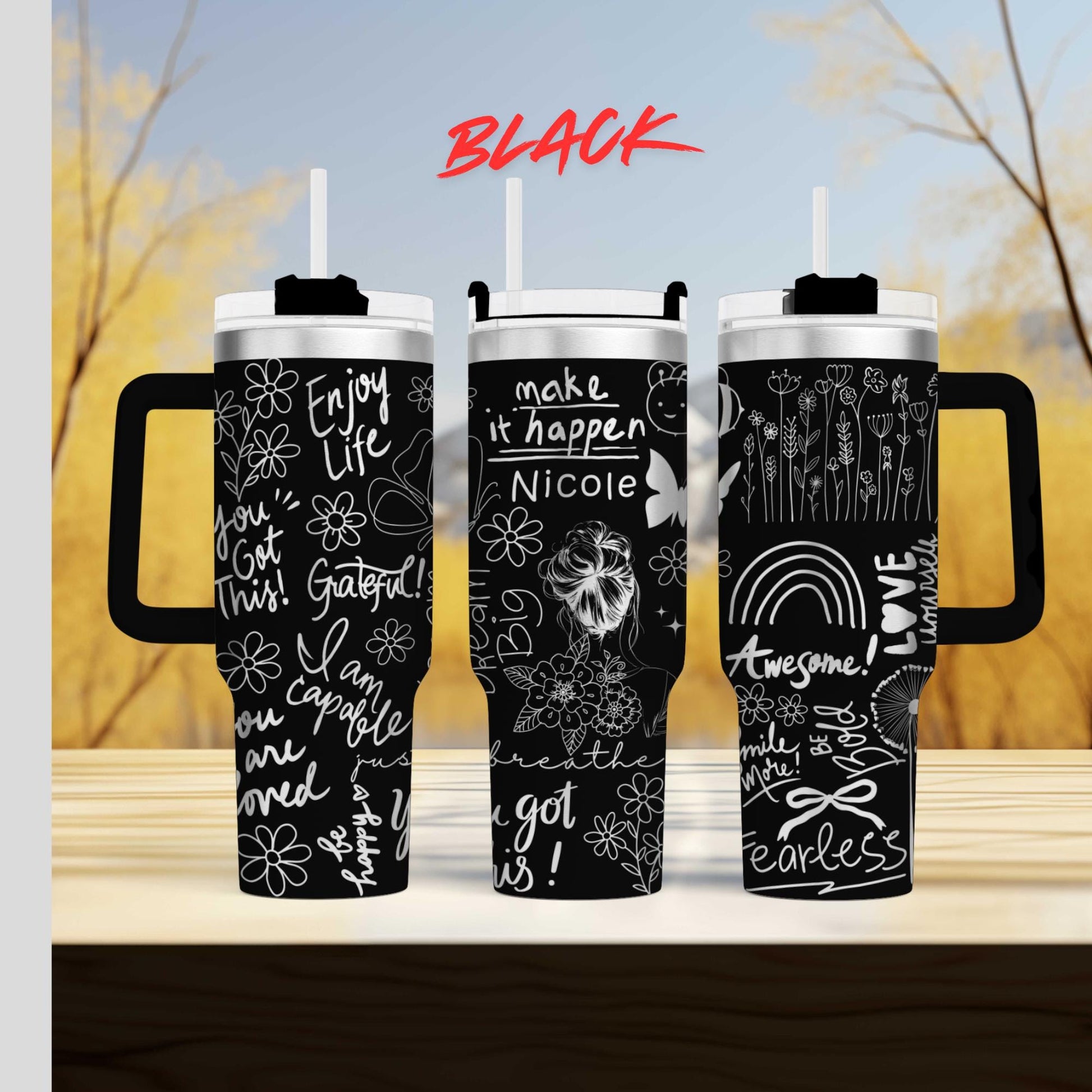 three travel mugs with different designs on them