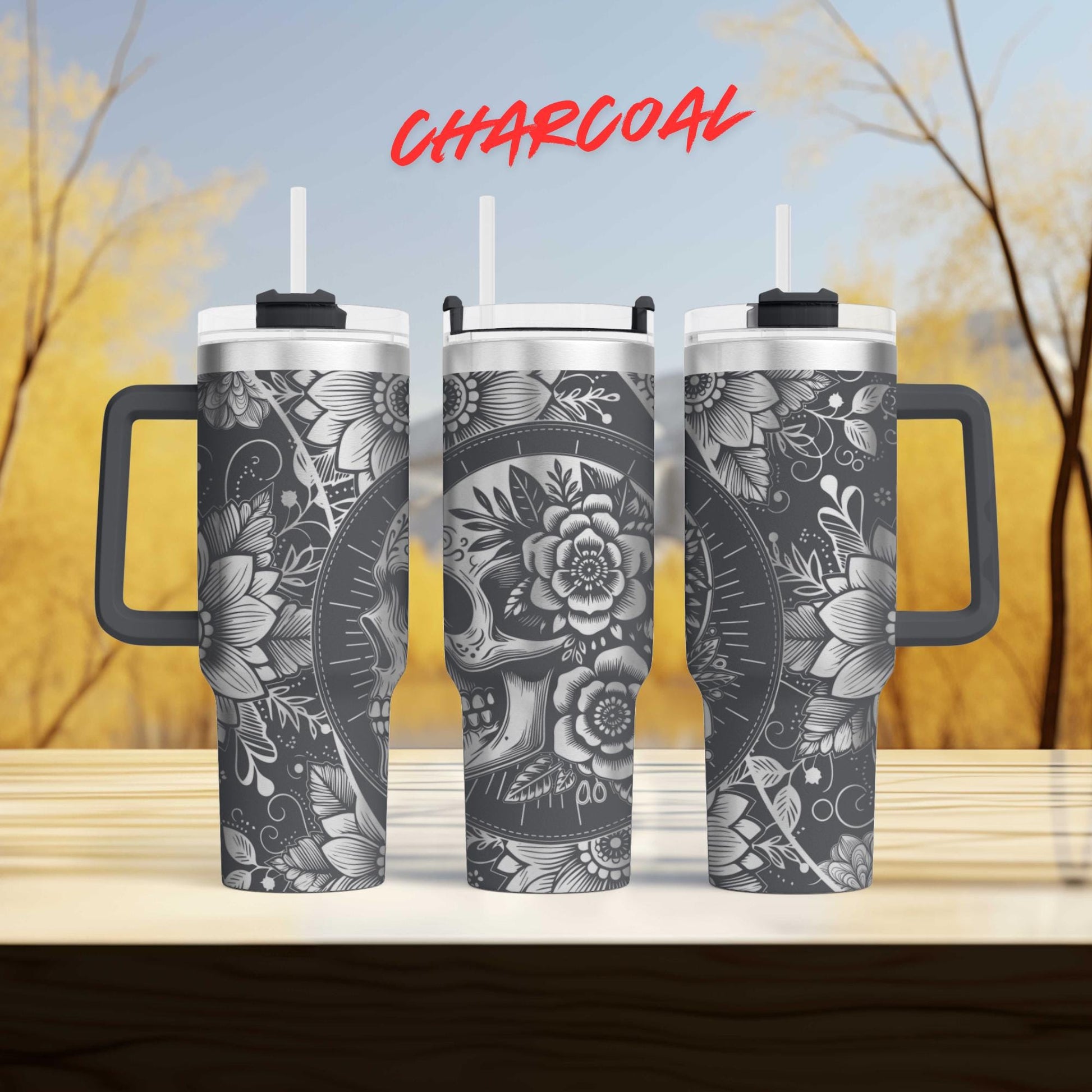 three travel mugs sitting on top of a wooden table