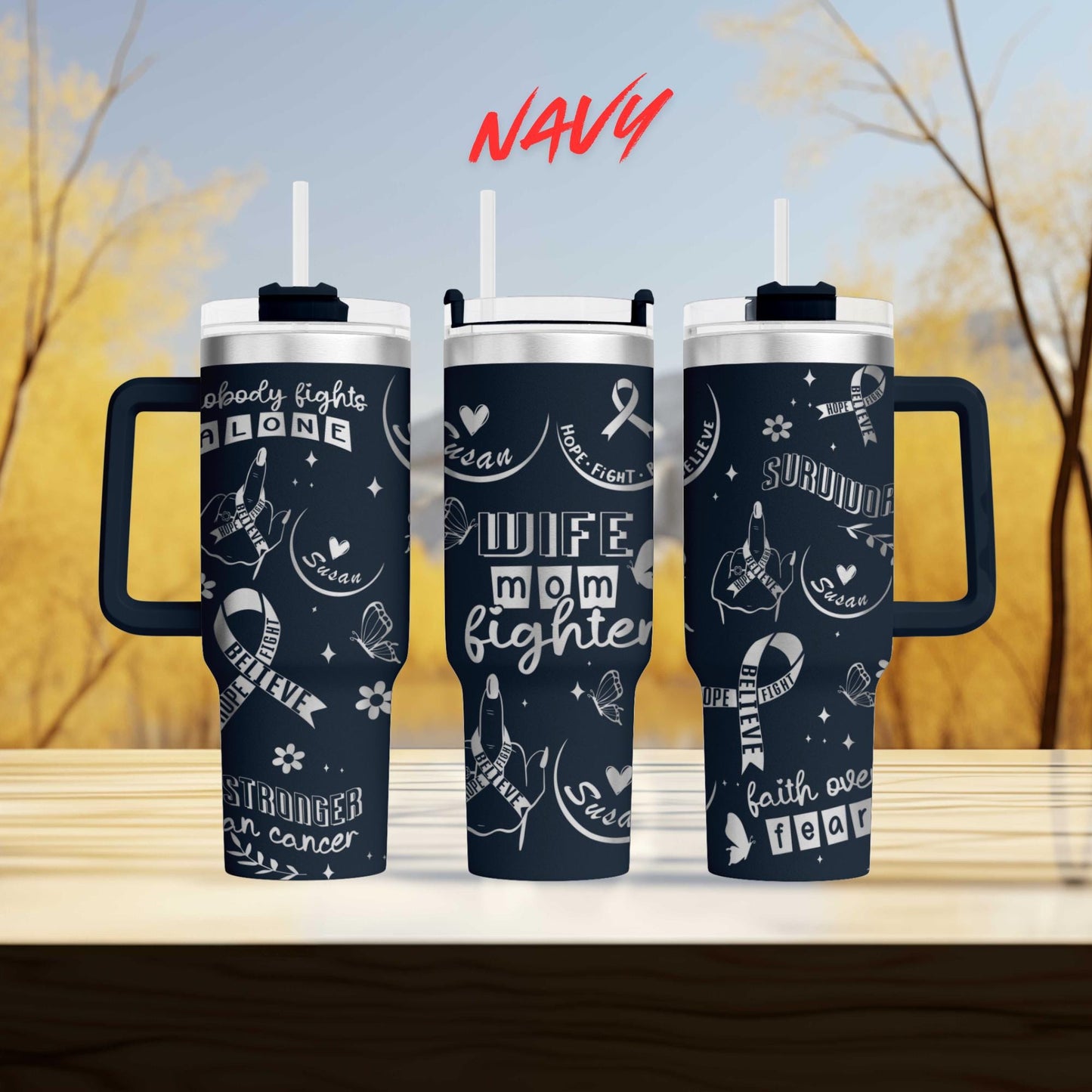 three travel mugs sitting on top of a wooden table