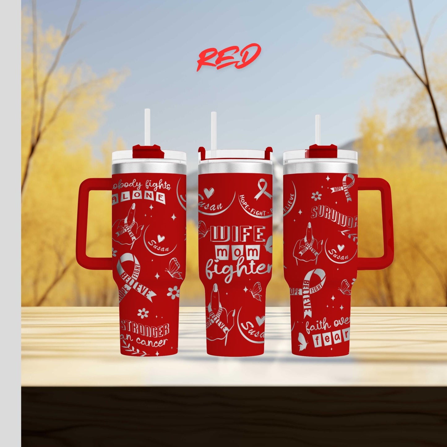 two red travel mugs sitting on top of a wooden table