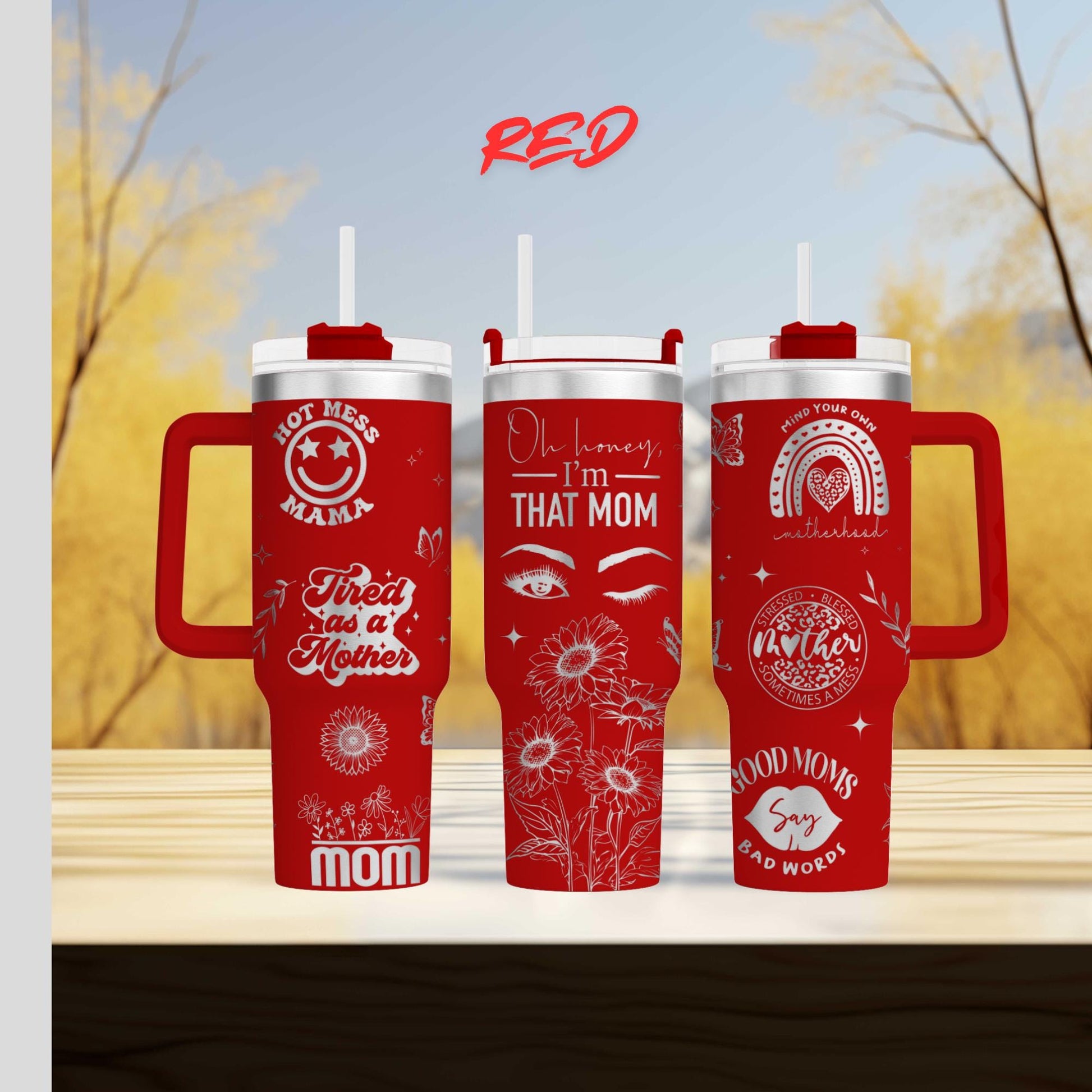 three red travel mugs sitting on top of a wooden table