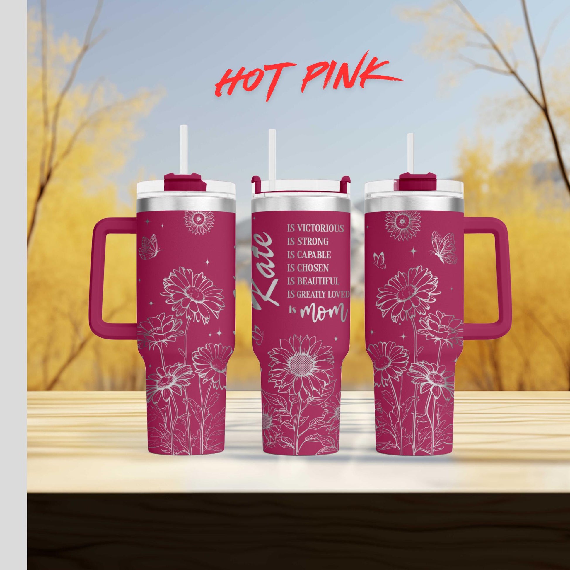 two pink coffee mugs sitting on top of a wooden table