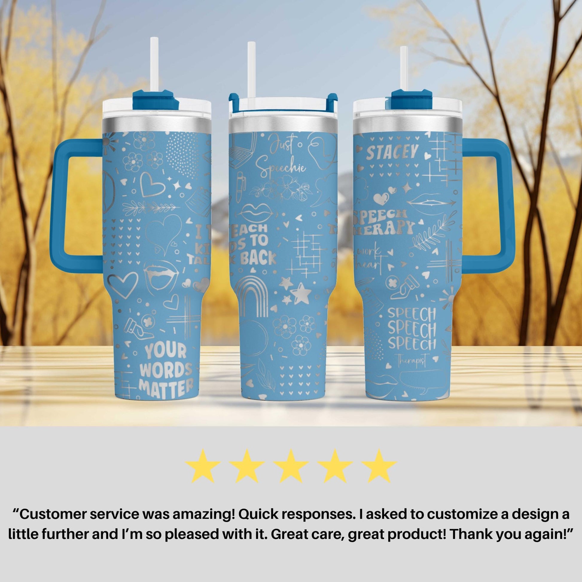 three blue tumblers with various designs and text on them, placed on a wooden surface against a blurred background of trees.