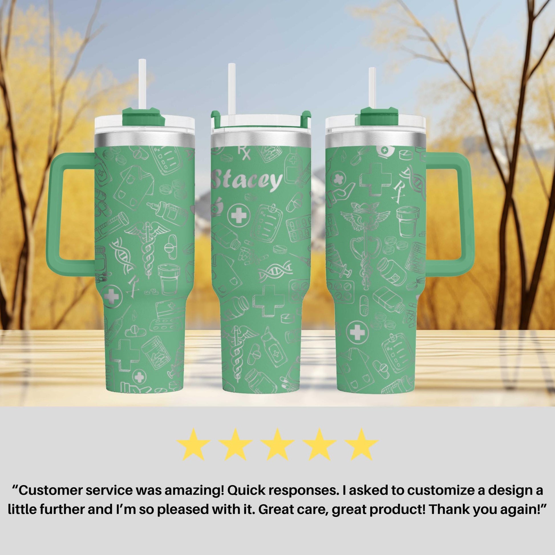 three green tumblers with white medical symbols printed on them, placed on a wooden surface against a blurred background of trees.
