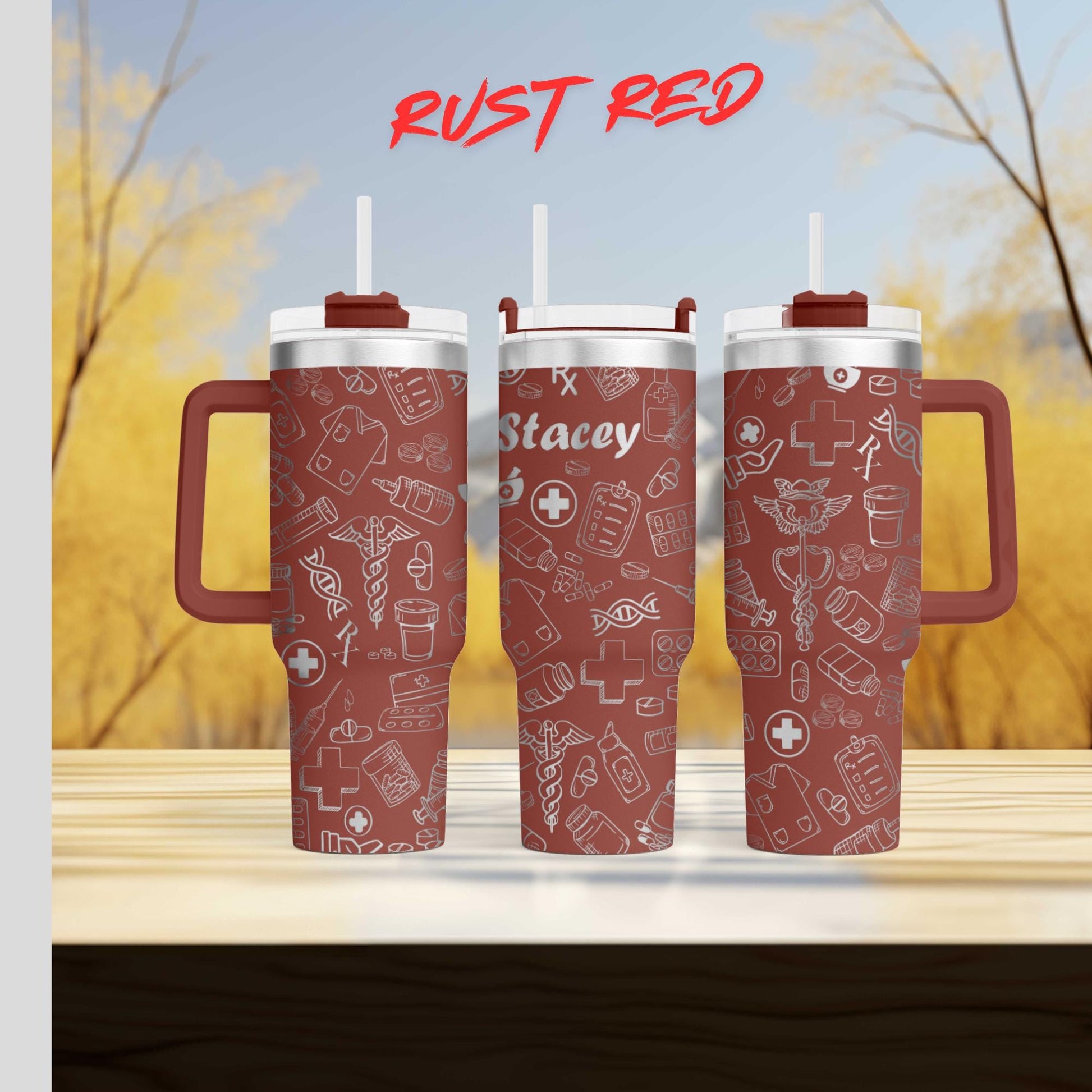 three red insulated tumblers with white medical-themed designs, including a cross, stethoscope, and other medical symbols. The tumblers have a rust-colored finish and are placed on a wooden surface.