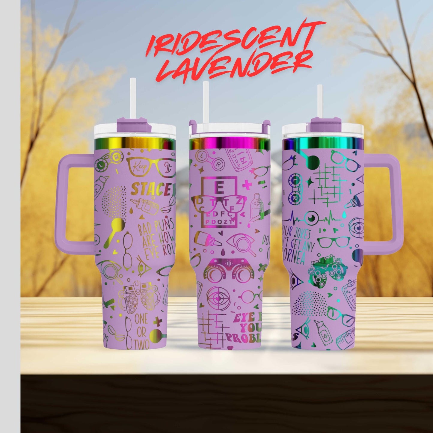 three purple tumblers with various designs and text on them, placed on a wooden surface against a blurred background.