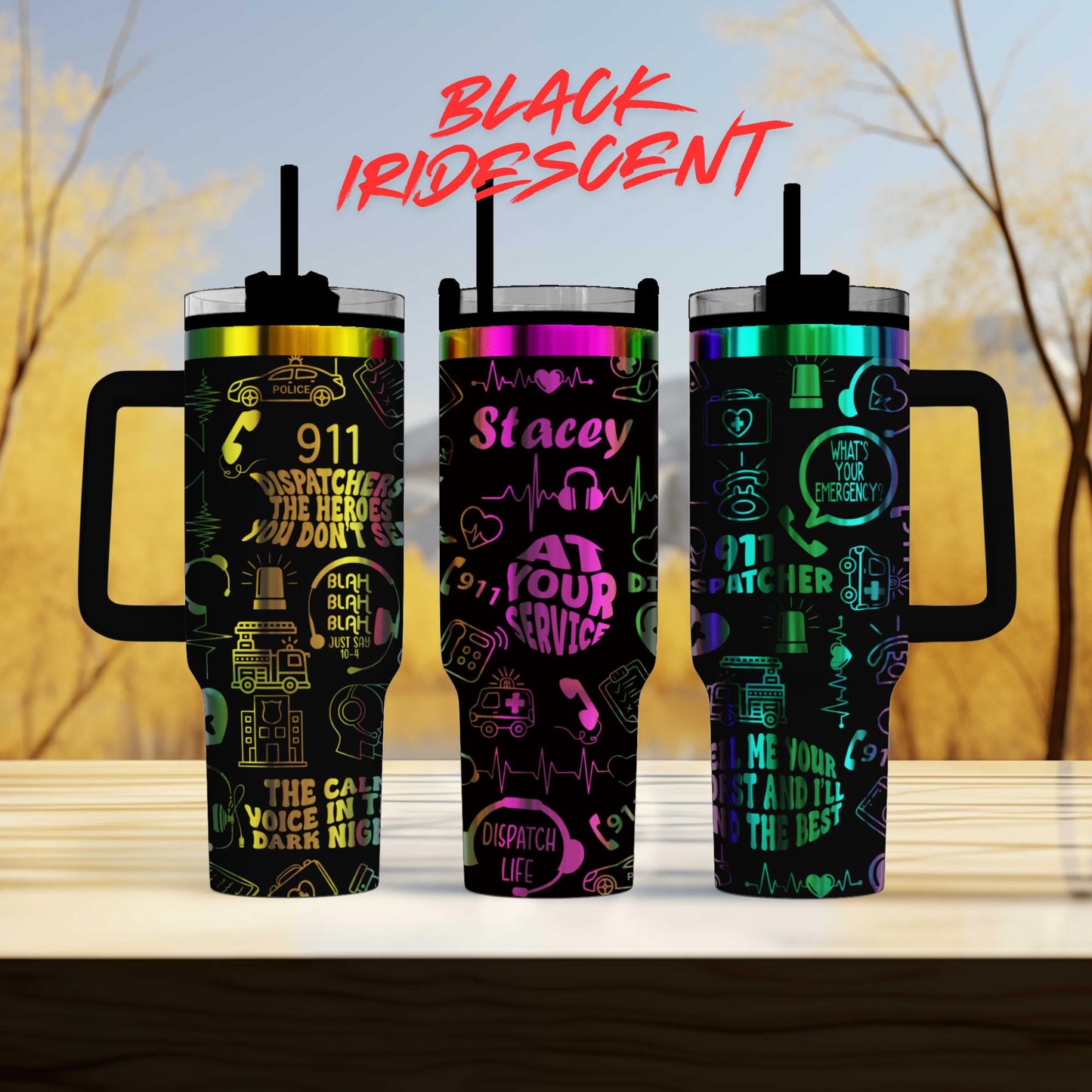 three colorful tumblers with various designs and text on them, placed on a wooden surface against a blurred background.