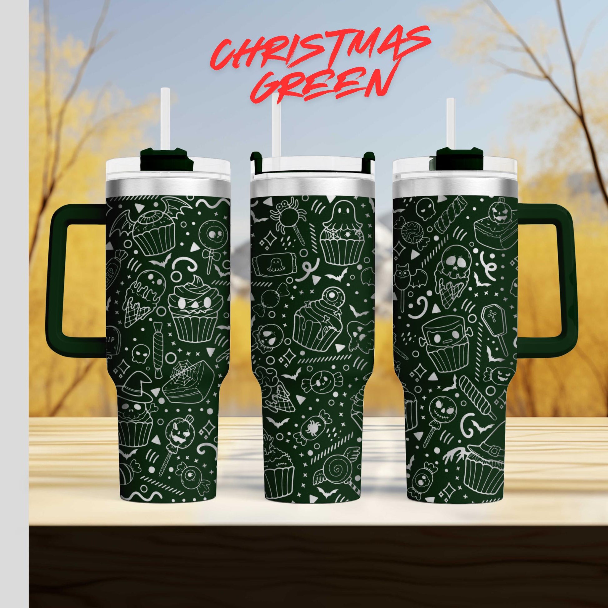 three green tumblers with white and black designs on them, placed on a wooden surface against a blurred background.