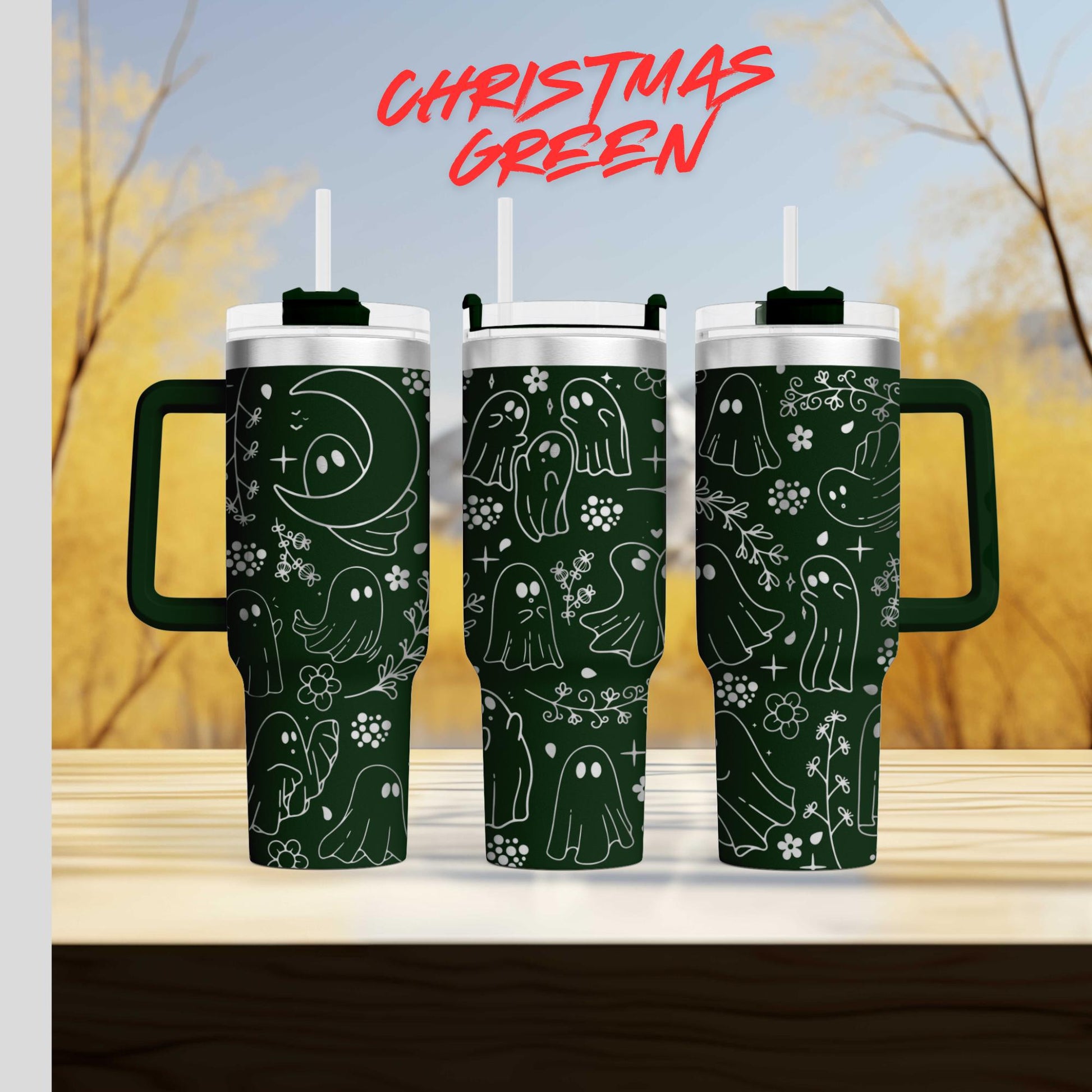 three green tumblers with a whimsical ghost design on them, set against a blurred background of trees and a blue sky.