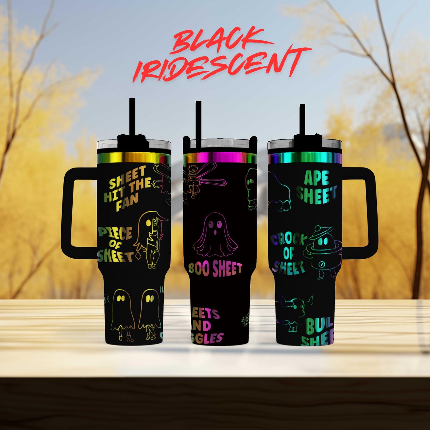 three colorful tumblers with ghost designs on them, set against a blurred background of trees.