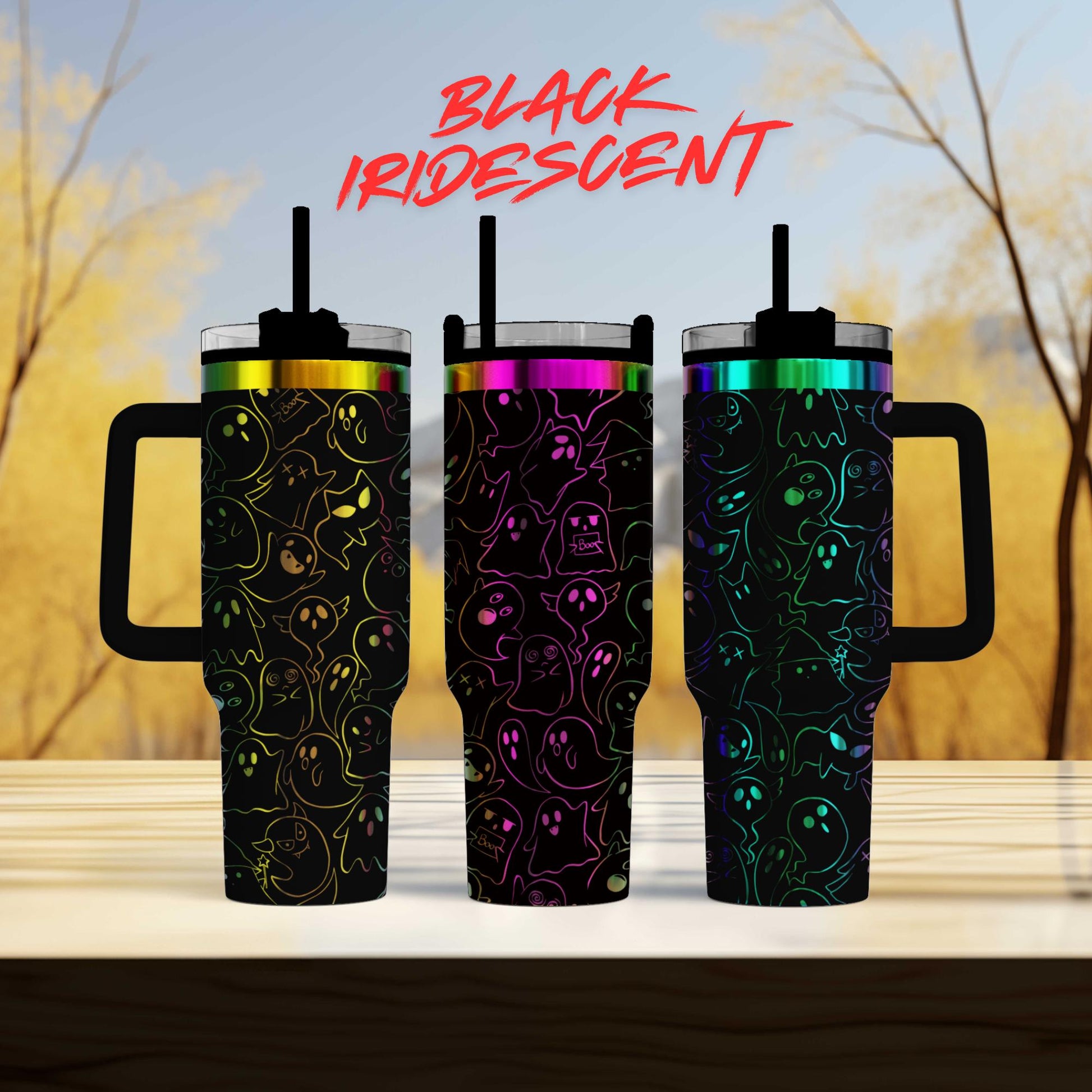 three colorful, patterned tumblers with handles, arranged in a row on a wooden surface.