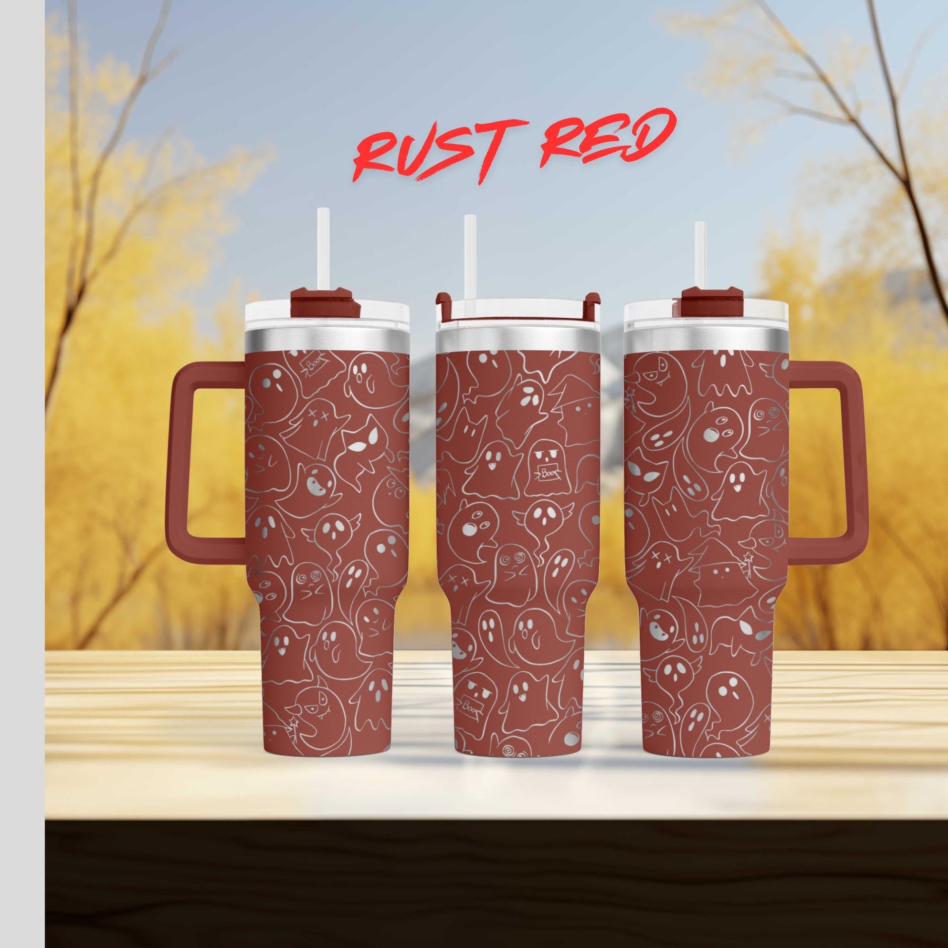 three red tumblers with a pattern of white ghost-like figures on them, set against a blurred background of trees and a blue sky.