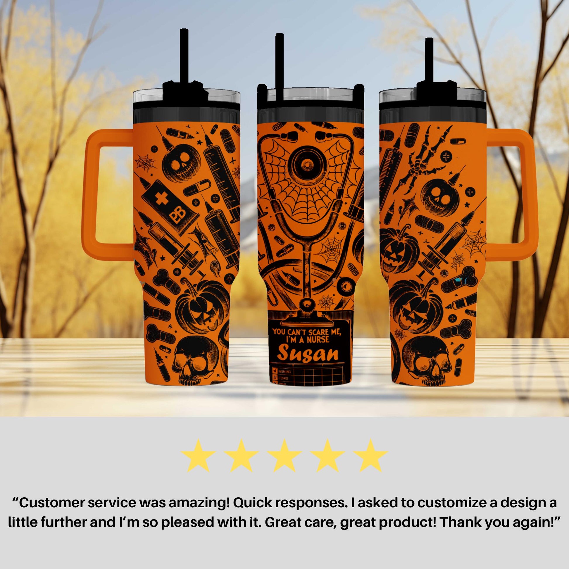 three orange tumblers with black and orange Halloween-themed designs, including skulls, bats, and pumpkins. The tumblers have handles and straws, and the background is blurred, suggesting a natural outdoor setting.