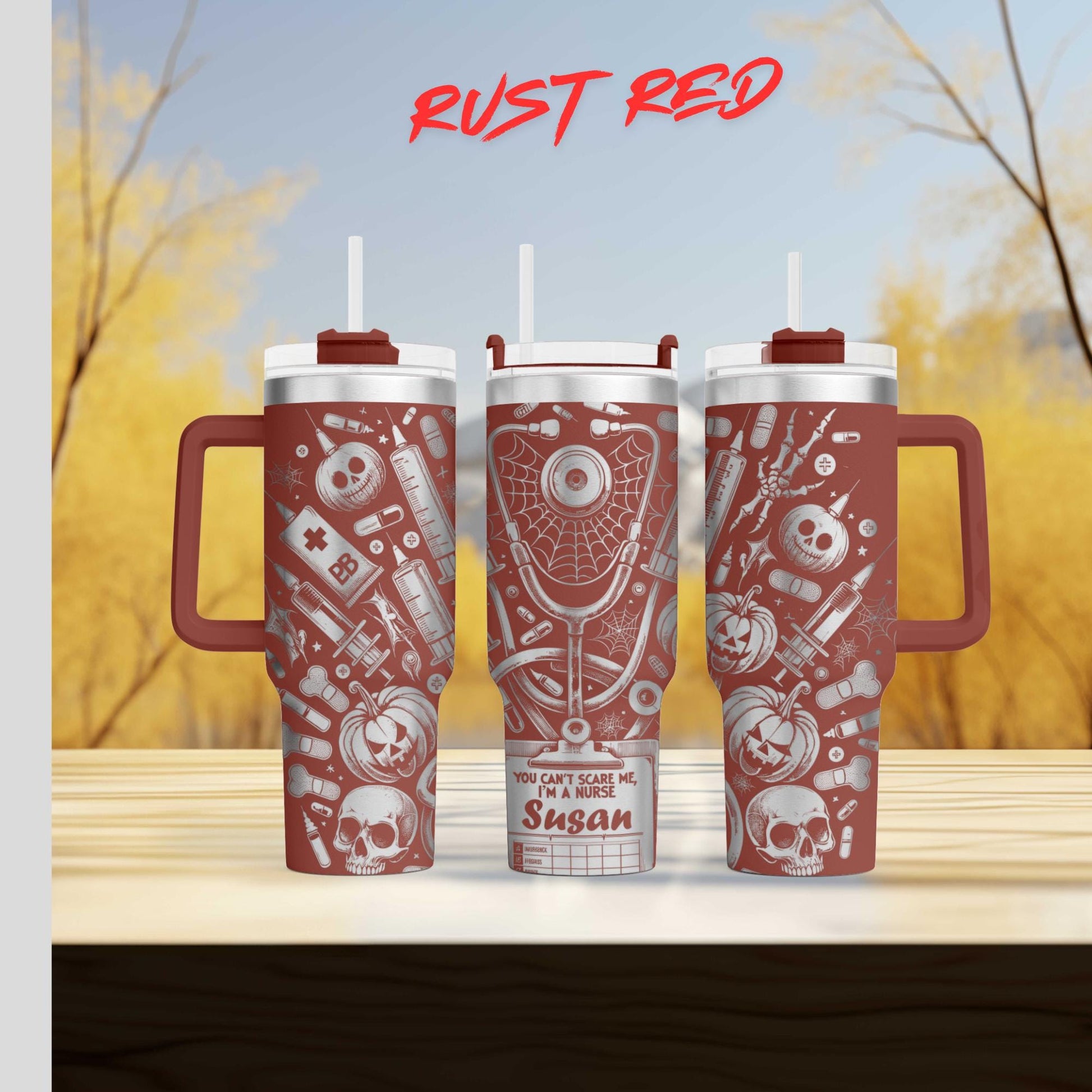 three red tumblers with various medical and Halloween-themed designs on them, placed on a wooden surface against a blurred background of trees.