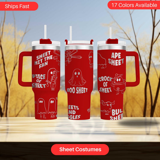 three red tumblers with white text and ghost-like designs, including the words "SHEET HIT THE FAN", "Piece OF SHEET", "CROCK OF SHEET", "BUL sheet", and "BUL sheet". The tumblers are displayed on a wooden surface against a blurred background of trees.