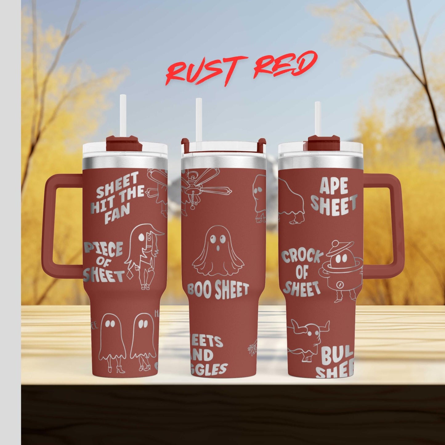 three red tumblers with white text and illustrations on them, set against a blurred background of trees and a blue sky.