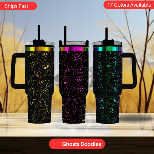 three colorful, skull-patterned tumblers or mugs with handles, arranged in a row against a blurred background of trees.