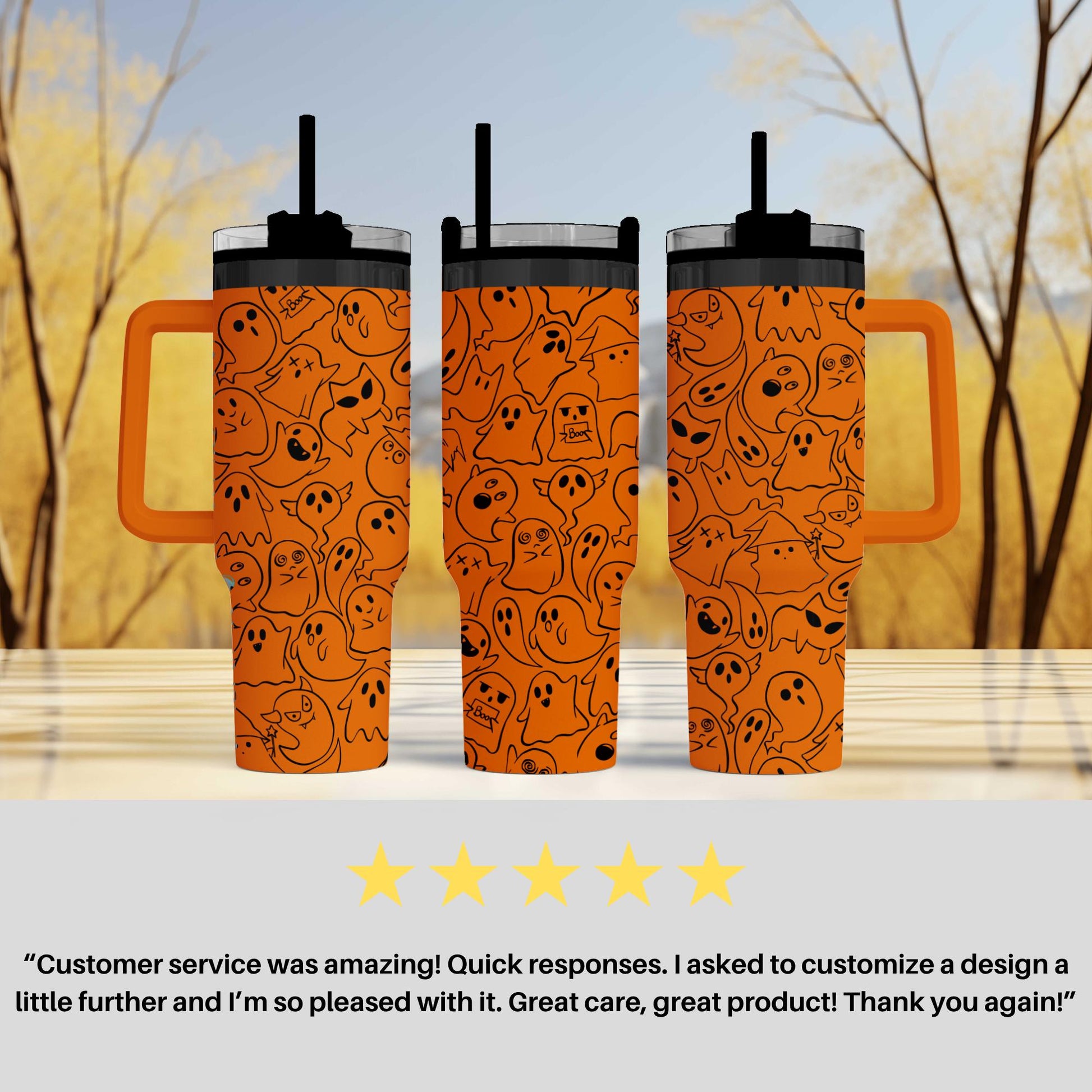 three orange tumblers with a unique design of black ghost faces on them, placed on a table against a blurred background of trees.