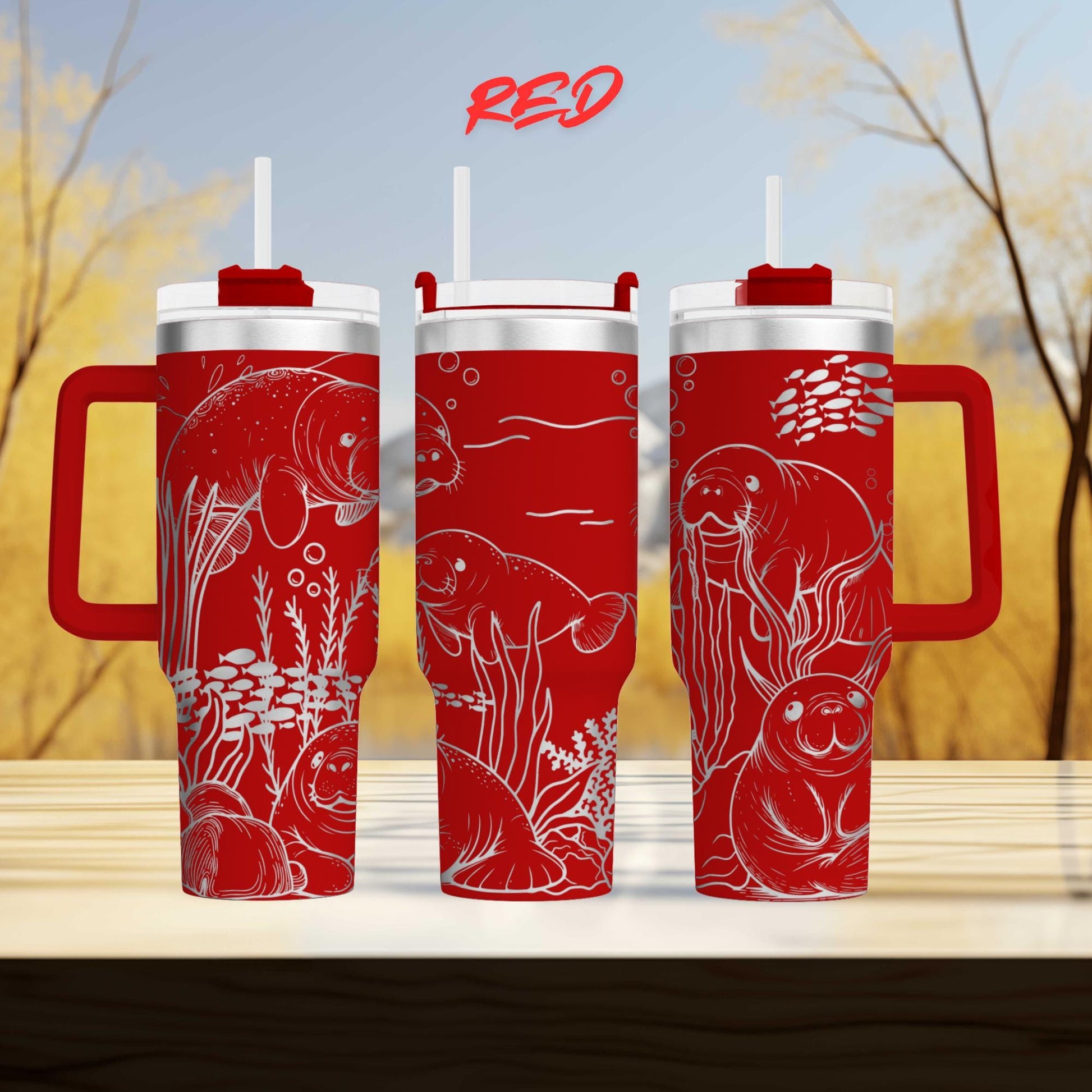 three red tumblers with illustrations of sea animals, including a manatee, on their surfaces.