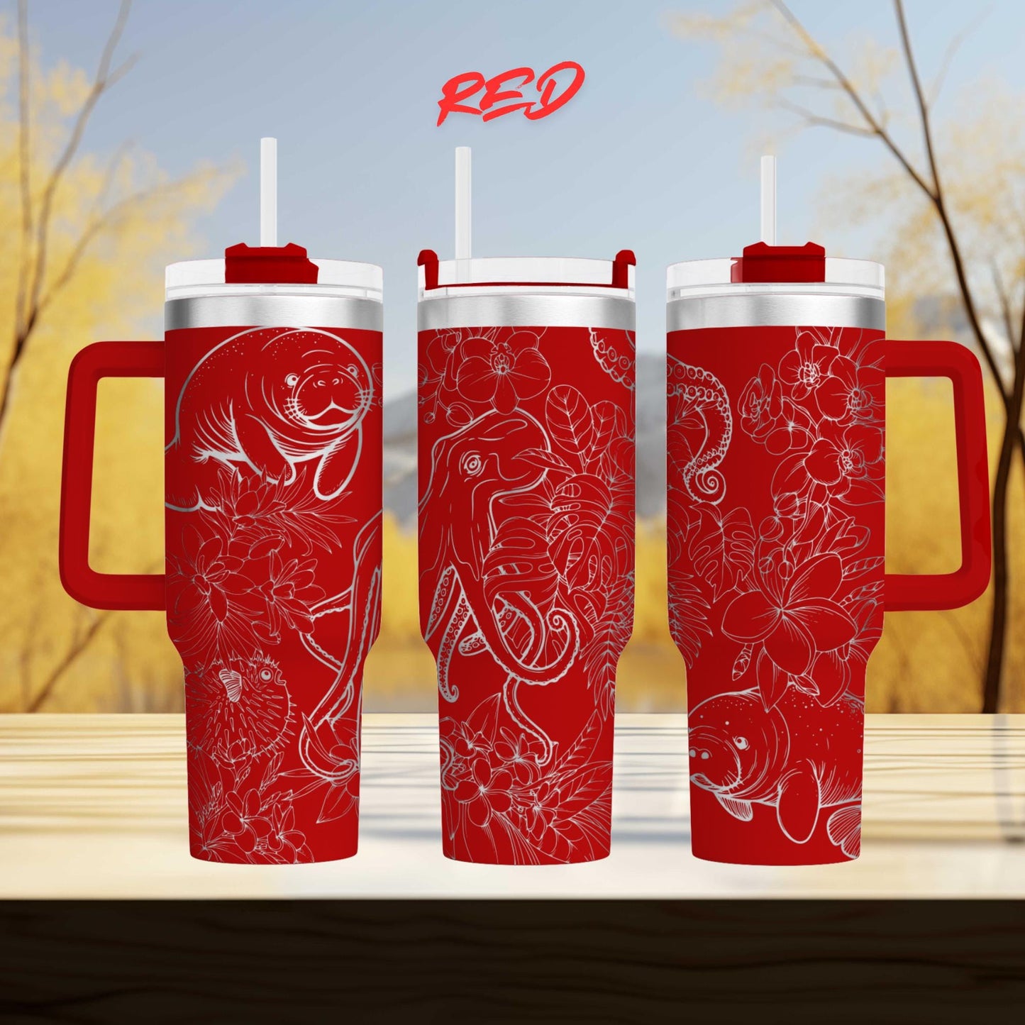 three red tumblers with floral designs on them, placed on a wooden surface against a blurred background.
