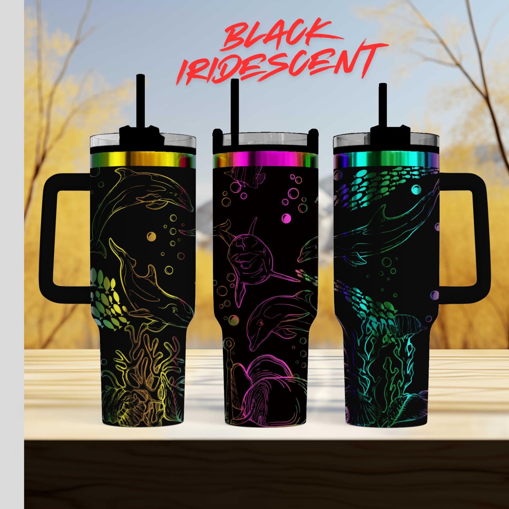 Three colorful, patterned insulated tumblers with handles, featuring marine life designs such as fish, dolphins, and coral.