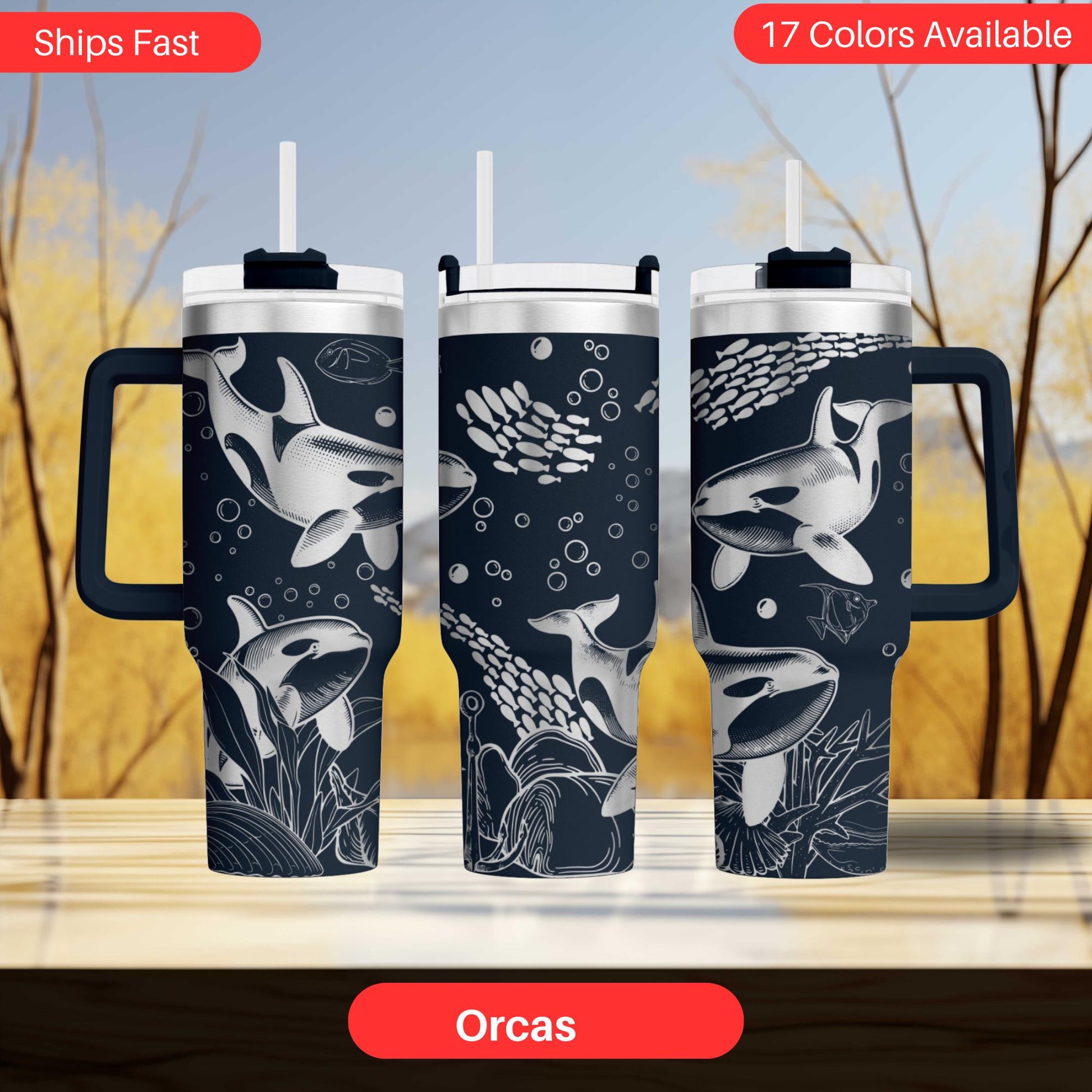 three black and white or silver-colored tumblers with orca whale designs printed on them.