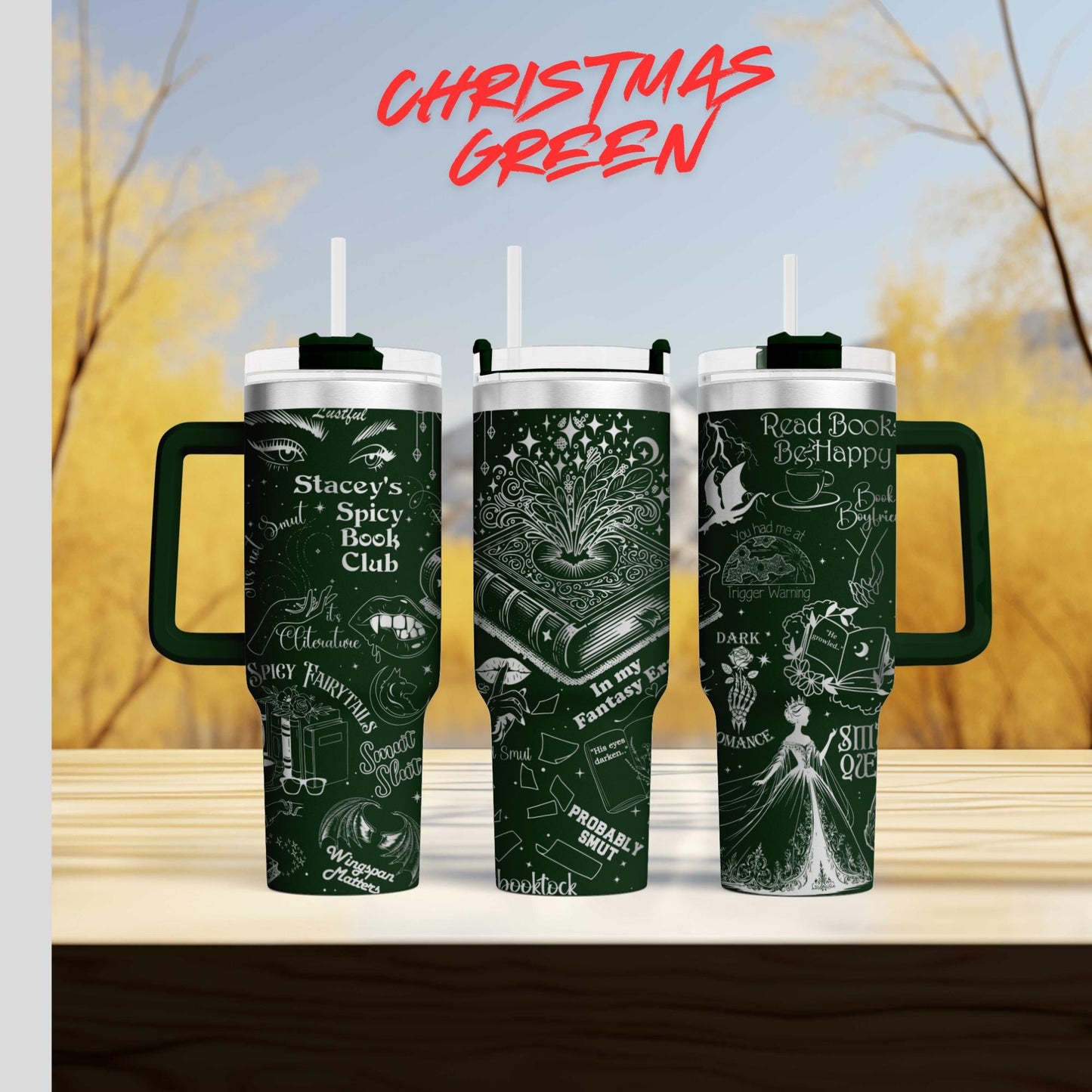 three green tumblers with white text and illustrations on them, set against a blurred background of trees and a blue sky.
