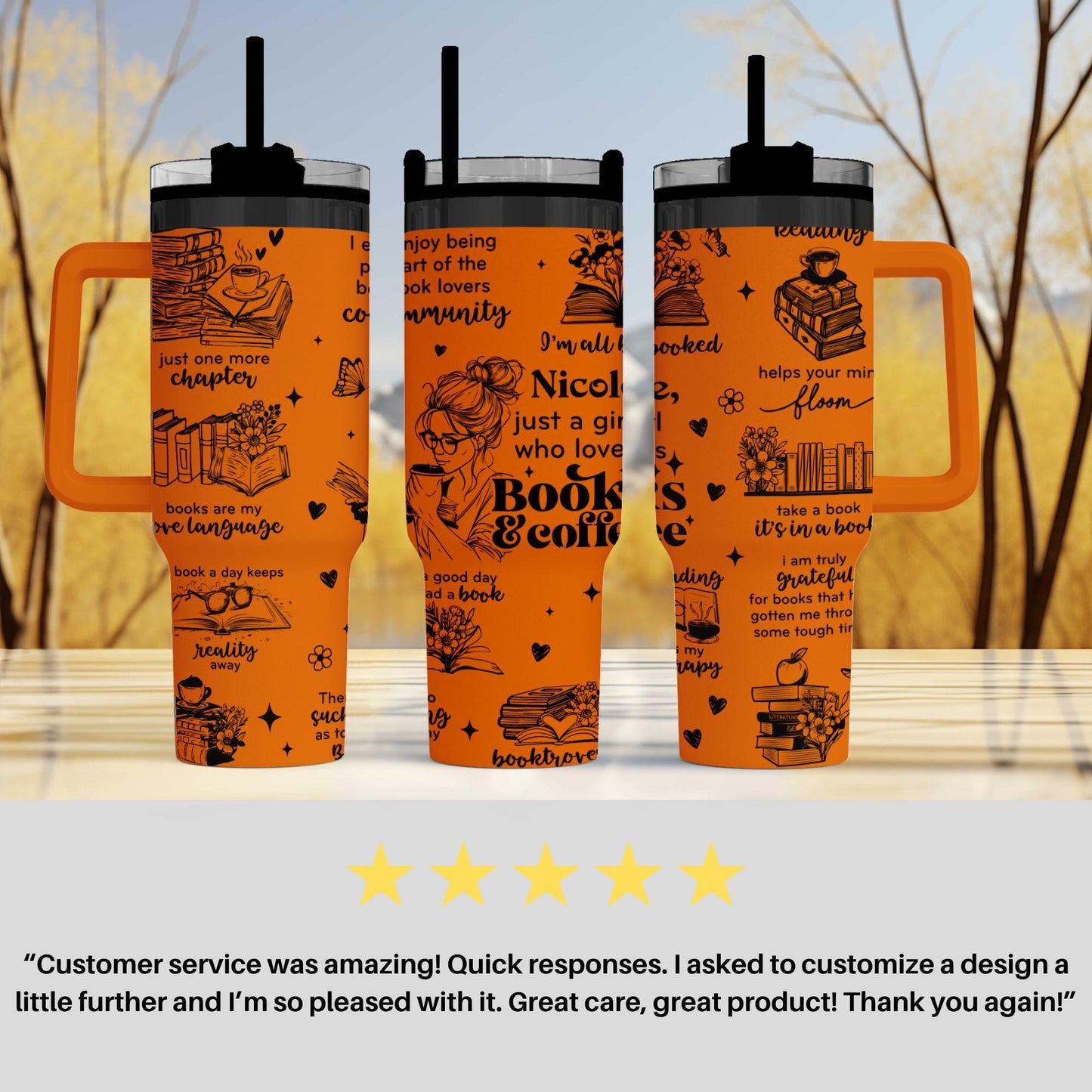 three orange tumblers with black text and illustrations on them, placed on a table against a blurred background.